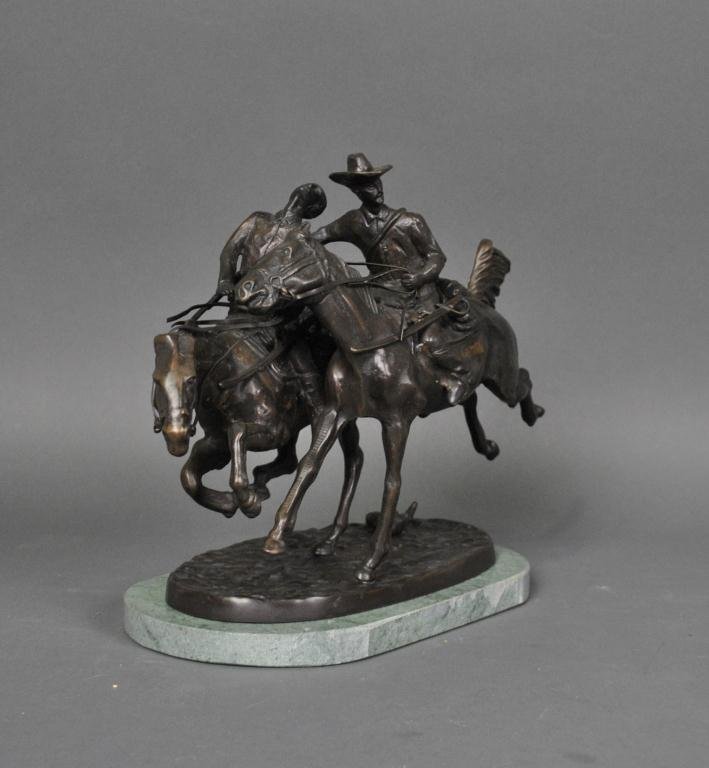 AFTER FREDERIC REMINGTON - WOUNDED BUNKIE: bronze sculpture, incised signature, on mottled green marble base, 10x13x6in.