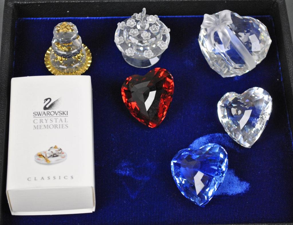 SIX SWAROVSKI CRYSTAL OBJECTS - HEARTS & CAKES: including three hearts - blue, red, and clear, a three-tier cake, a birthday cake, and a piece of cake (in box), tallest 2in.