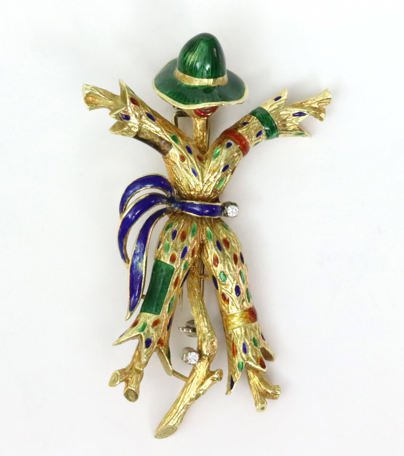 LARGE 18K ENAMELED SCARECROW CLIP BROOCH: in polychromed enamels accented with 2 round diamonds (some enamel wear, minor dent to hat), in yellow gold (clip in white gold), stamped '1846 18K', 2.75in., 25.1gms., Opening Bid $1200