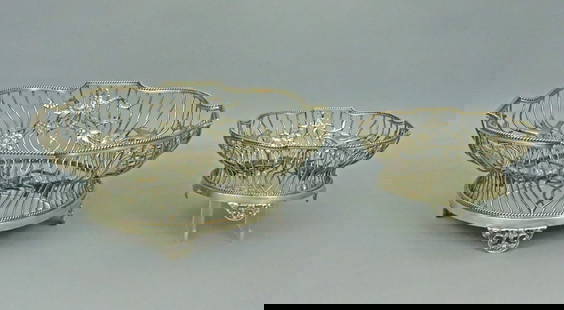(2) PC. ENGLISH STERLING BASKET GROUP: decorated in festoons of ribbons, florals and birds, on floral and scroll feet, with punch marks for Sterling, London, 1908, and W.C for William Comyns & Sons, both marked for London retailer Carringt