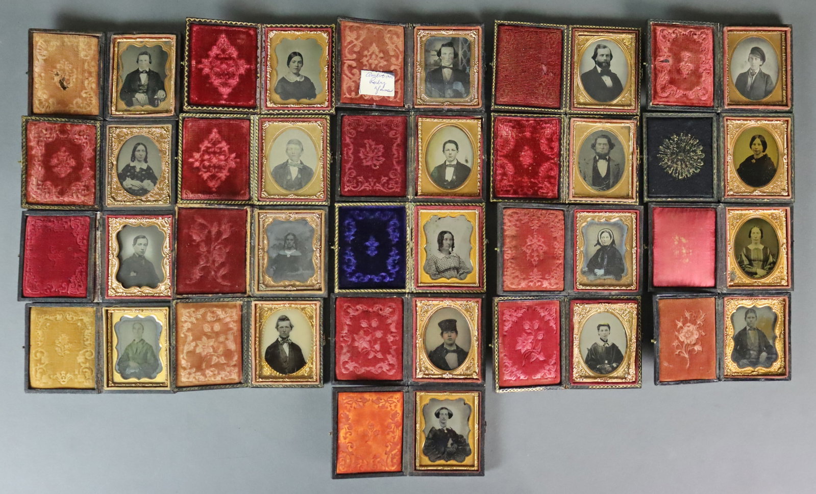 (21) 1/9 PLATE AMBROTYPES - ADULT PORTRAITS: All in full pressed paper cases, one elder in fully tinted green dress, some plates with tinting, a couple with gilt. CONDITION: Conditions vary with the wear and tear and typical imperfections of a c