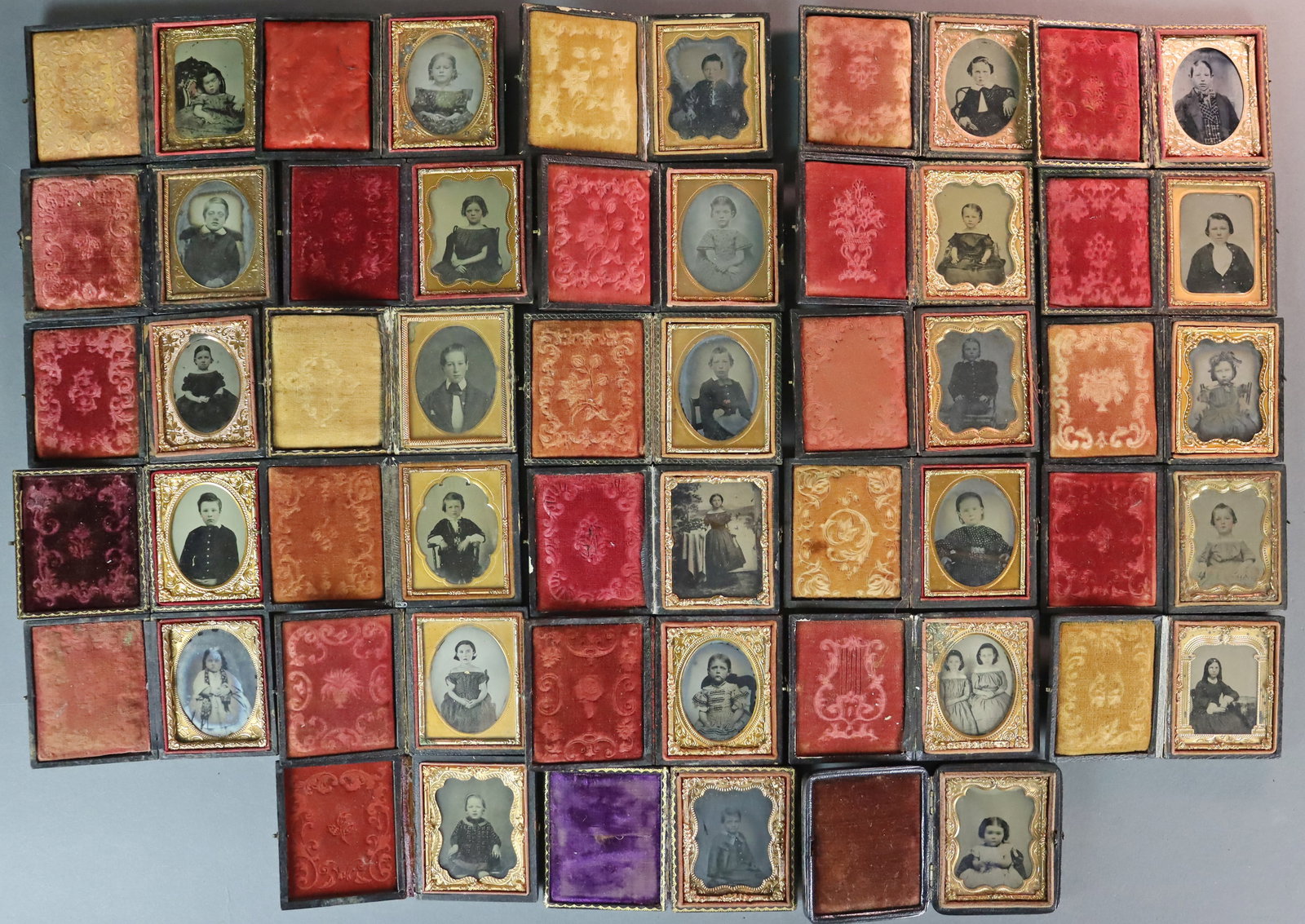 (28) 1/9 PLATE AMBROTYPES - CHILDREN: All in full pressed paper cases (one in book form), some with tinting, a couple with gilt accents. CONDITION: Conditions vary with the wear and tear and typical imperfections of a cased ambrotype whic