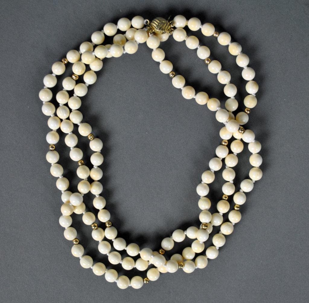 3-STRAND IVORY AND GOLD BEADED CHOKER: comprising 8mm beads with tested 14K spacers, clasp stamped 14K 585 S.C., safety catch, 16in.
