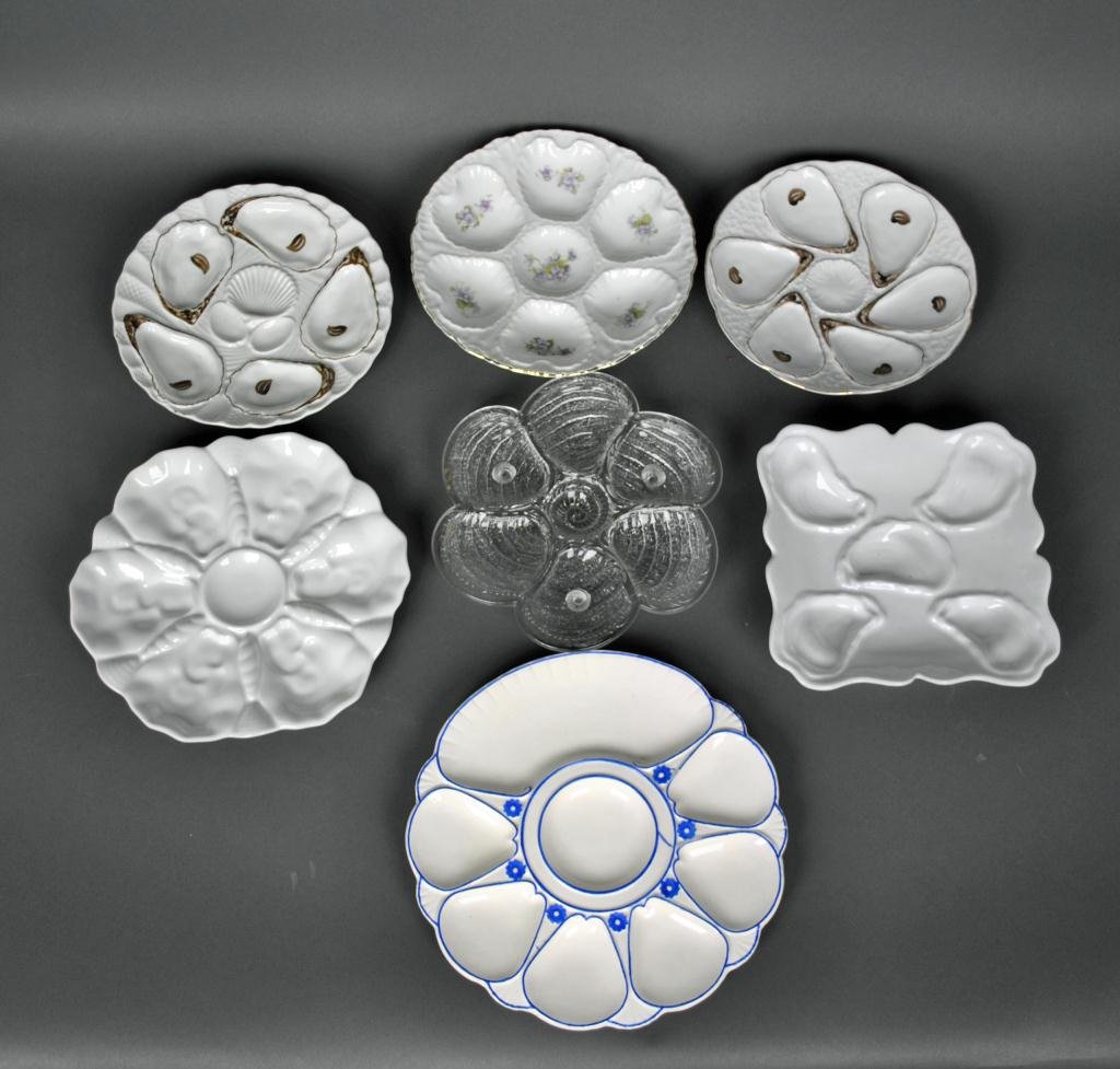 SEVEN OYSTER PLATES: mostly continental, including a Carlsbad Austrian floral, Bavarian, Minton with cracker well, clear glass with periwinkle feet, etc., largest 10in.