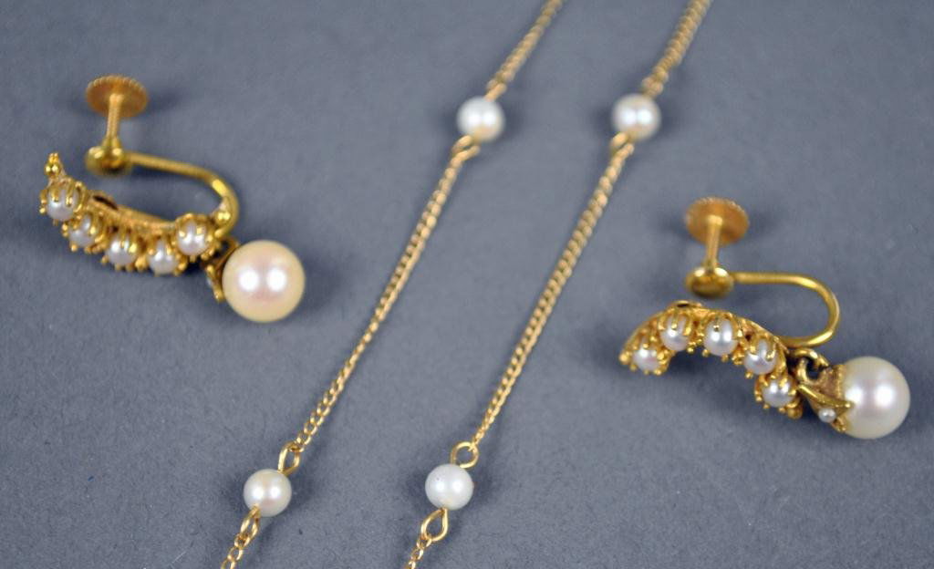 14K SEED PEARL NECKCHAIN AND EARRINGS: each screwback earring designed as a crescent moon set with seed pearls and a 6mm cultured pearl drop, together with a 17" neckchain with seed pearl spacers, all in yellow gold stamped 14K, 6.6gms.
