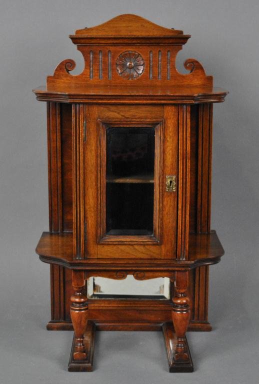 VICTORIAN MAHOGANY WALL CABINET AND SHELF UNIT: having a single beveled glass door, two side shelves and a larger top shelf, carved floral medallion, lower beveled mirror panel, no key, 24x14x9in.