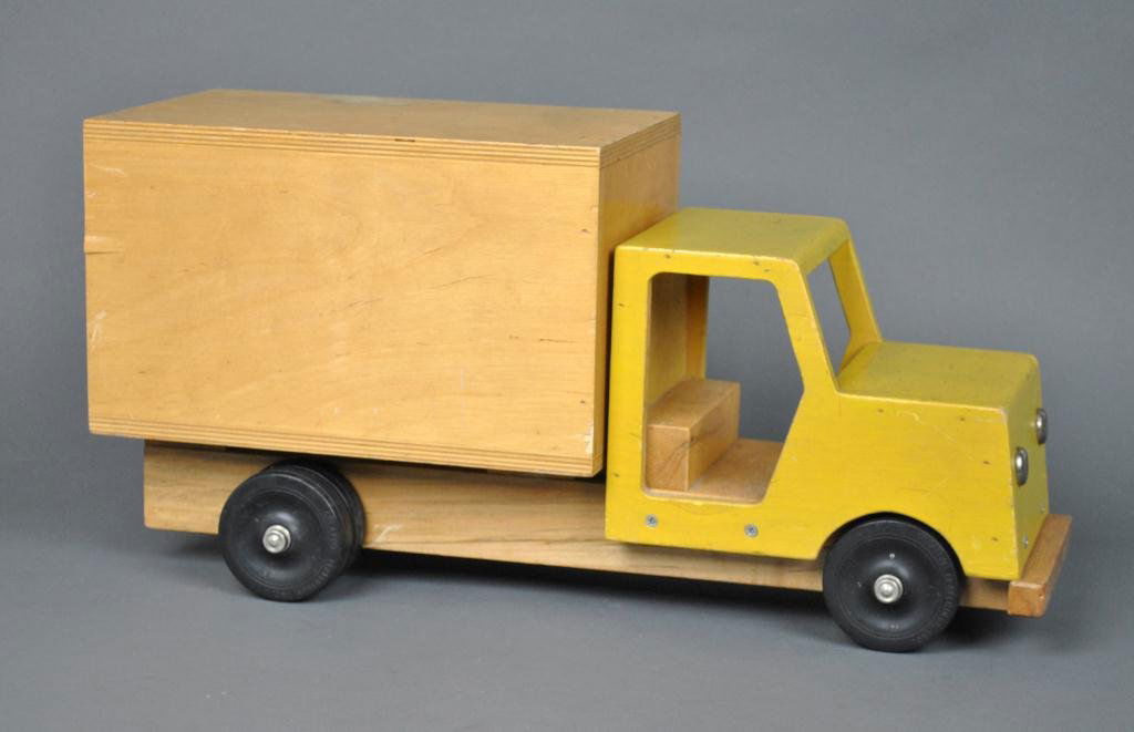 1960 WOOD TRUCK BY CREATIVE PLAYTHINGS: with yellow-painted cab, stamped to front fender and tires 'Creative Playthings Princeton, NJ', wear and some wood splits, 10x21in.