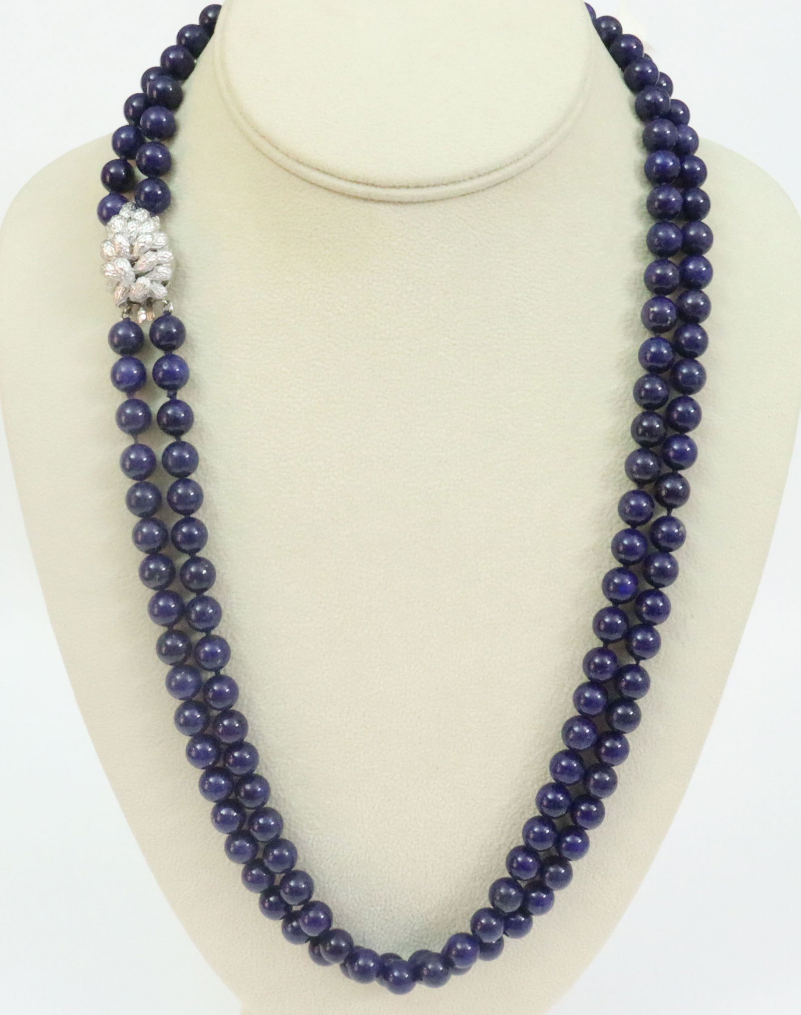LAPIS BEAD NECKLACE WITH 14K CLASP: comprising a double strand of 8mm lapis beads, the white gold clasp in carved acorn design with safety catch, 23in.