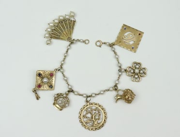 14K CHARM BRACELET WITH (7) 14K CHARMS