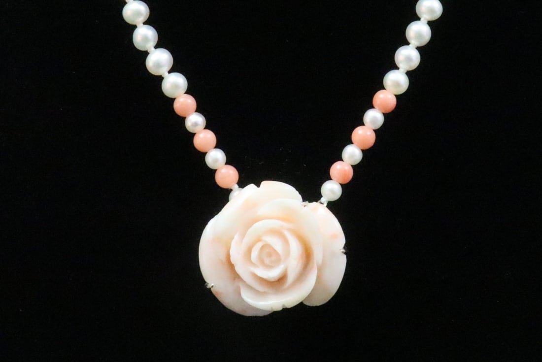 14K PEARL & CORAL ROSE PENDANT NECKLACE: comprising a single strand of 4mm cultured pearls accented with 6 coral beads, with carved coral rose pendant, 23x25mm, 14K stampings to white gold clasp and pendant mount, coral with minimal imperfec