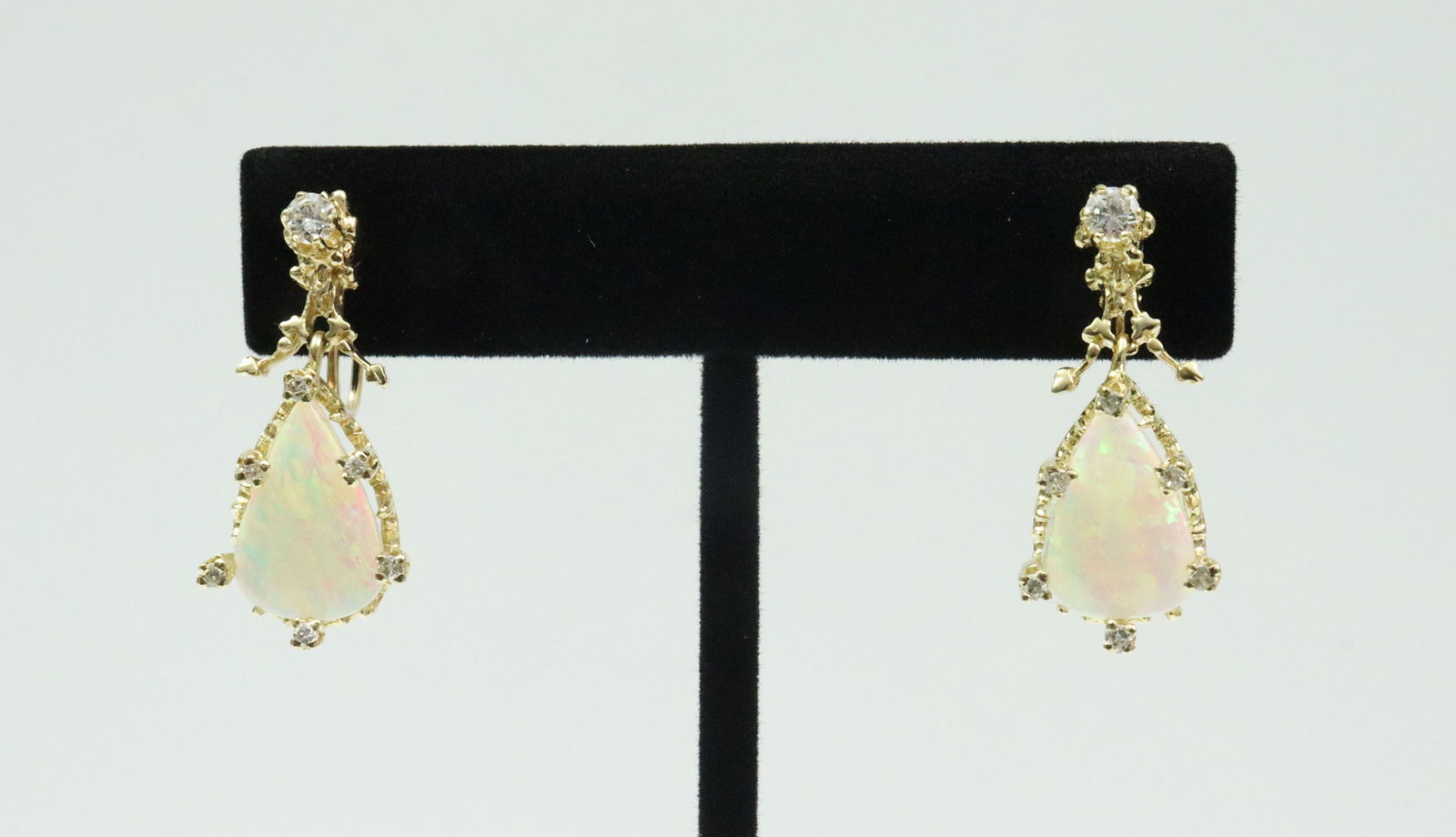 PAIR 14K DIAMOND & OPAL SCREW BACK EARRINGS: each set with a (15x9.5mm) pear shaped opal approx. 1.60ct, and 7 round natural diamonds (largest diamond approx. 15pts), total diamond weight for the pair 0.54ctw, in yellow gold, stamped 14K, 1.1in.