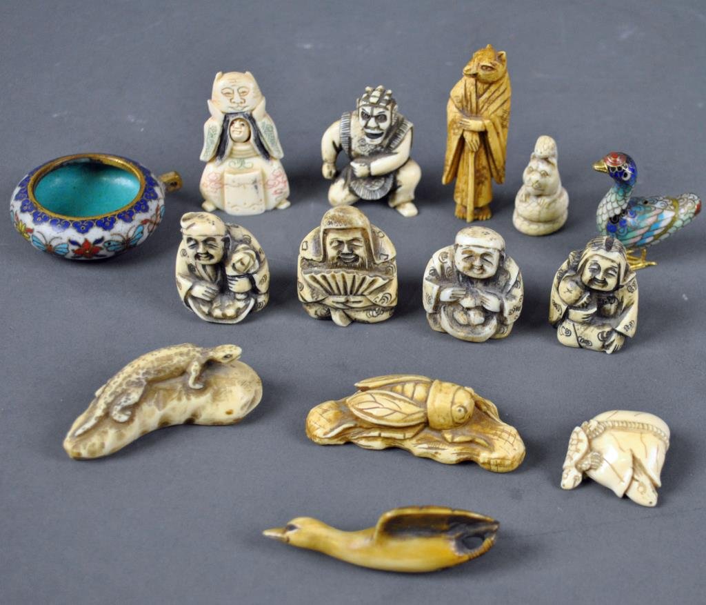 12-PIECE NETSUKE GROUP: including a costumed kinetic figure with movable two-sided face, an insect on branch, a lizard on rock, a flying goose, a fox priest (ear chipped), etc., one with Hong Kong Ivory label, some signed, t