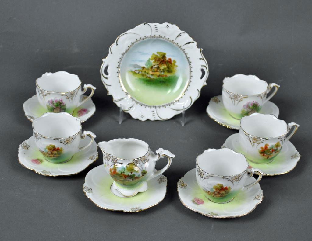 RS PRUSSIA CHILD'S PORCELAIN PARTIAL TEA SET: including 5 cups, 6 saucers, a creamer and a 5" service plate,