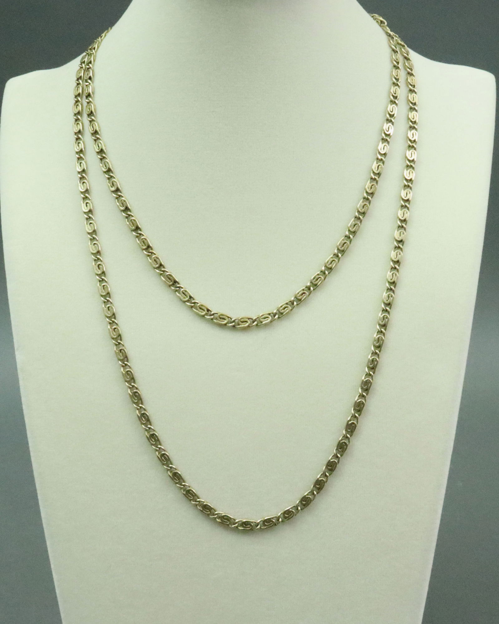 14K CONTINUOUS SCROLL CHAIN NECKLACE: the scroll links in claspless design, tests 14K, width 4mm, length 39in., 50.3gms., Opening Bid $3000