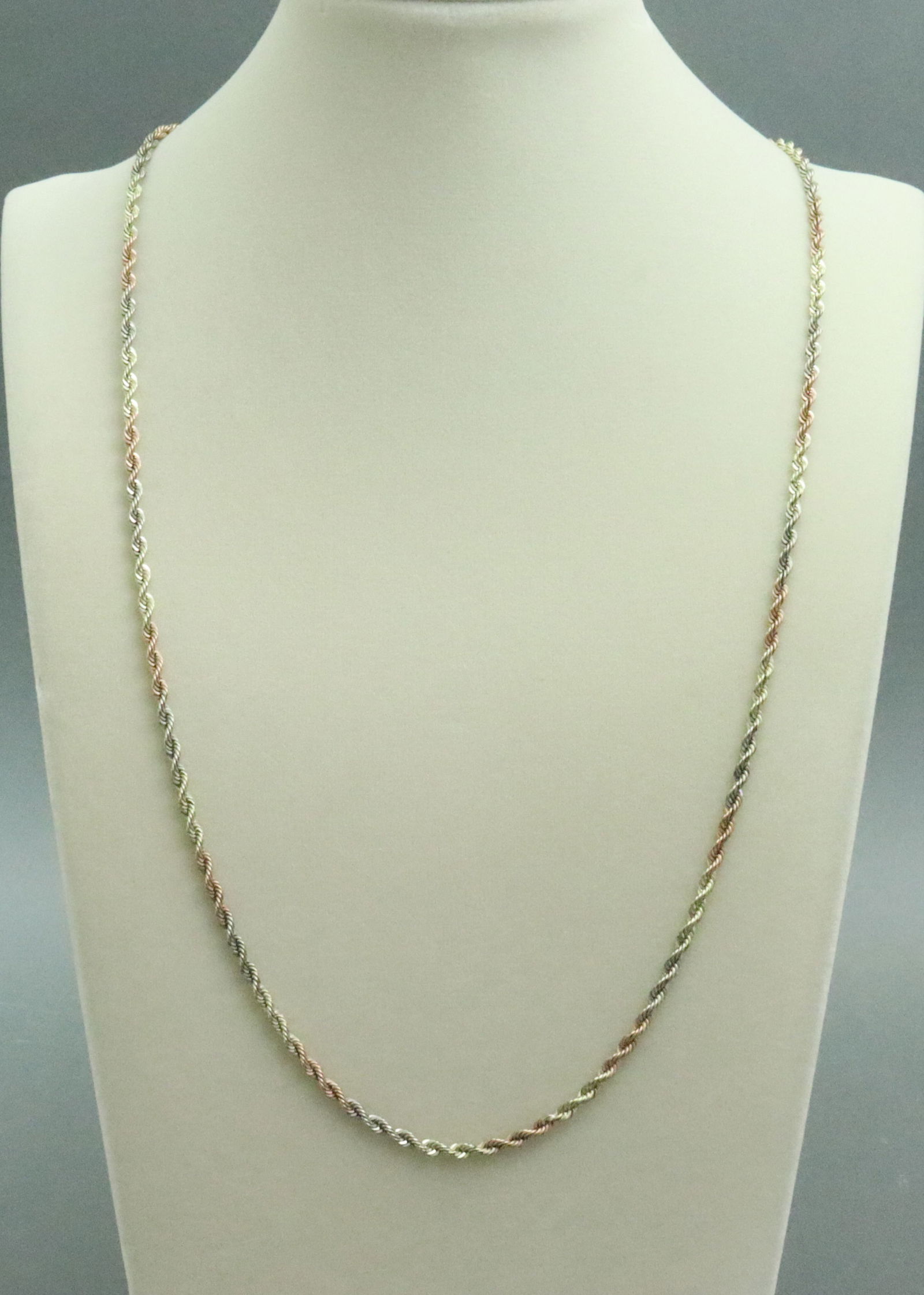 14K TRICOLOR ROPE CHAIN NECKLACE: in yellow, white and rose gold, stamped 14K, width 3mm, length 32in., safety catch, 27.7gms., Opening Bid $1600