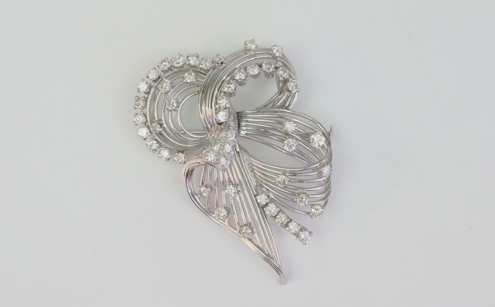 18K DIAMOND SPRAY BROOCH: in reticulated design, set with 49 round diamonds approx. 3.00ctw, in white gold, tests 18K (double bales test 14K), 2.2x1.5in., 17.3gms., Opening Bid $1400