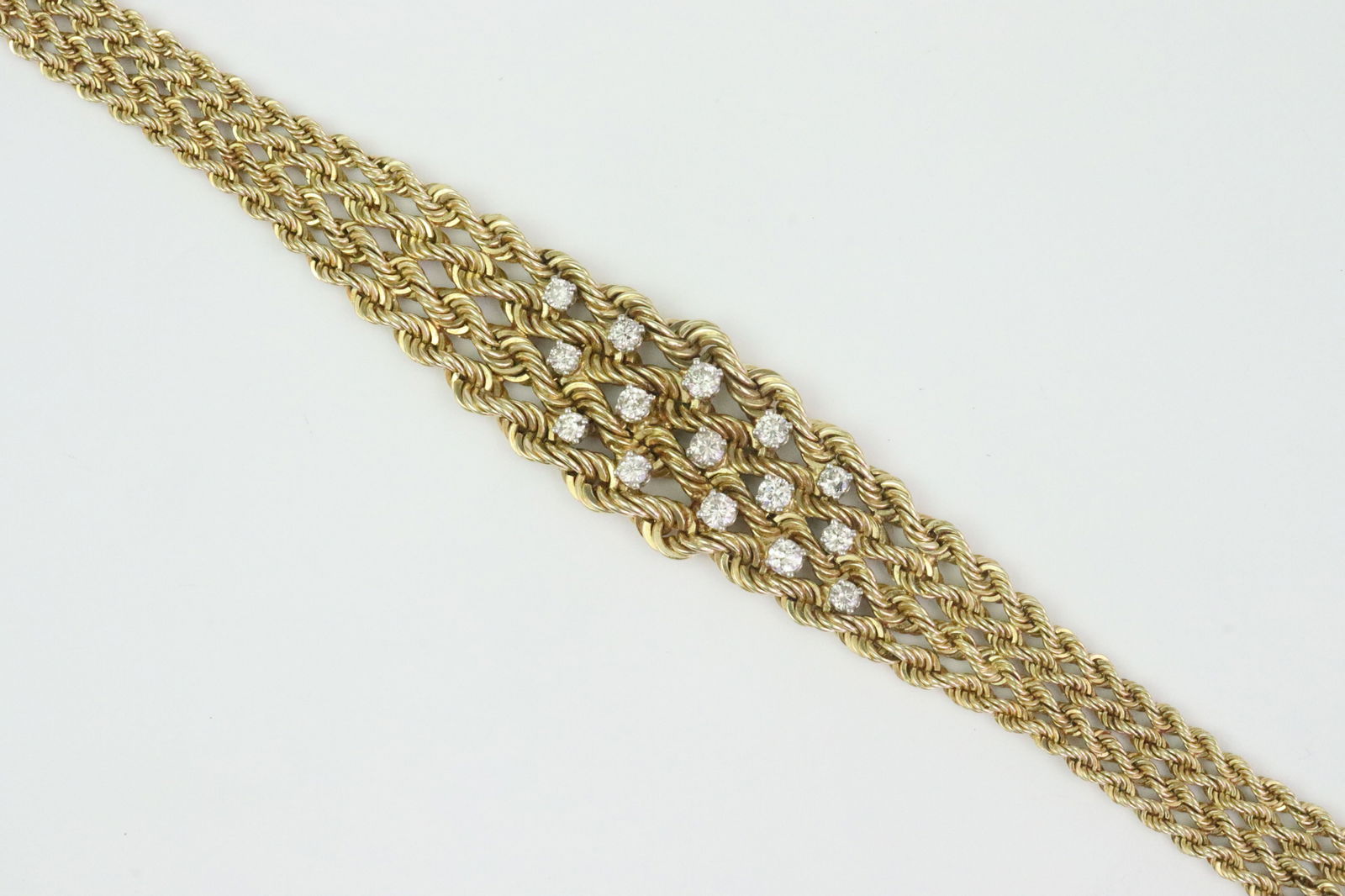 14K DIAMOND FANCY ROPE LINK BRACELET: set with 15 round diamonds approx. 1.00ctw, in yellow gold, stamped 14K, width 18mm at center, length 6.5in., safety catch, 21.8gms., Opening Bid $1200