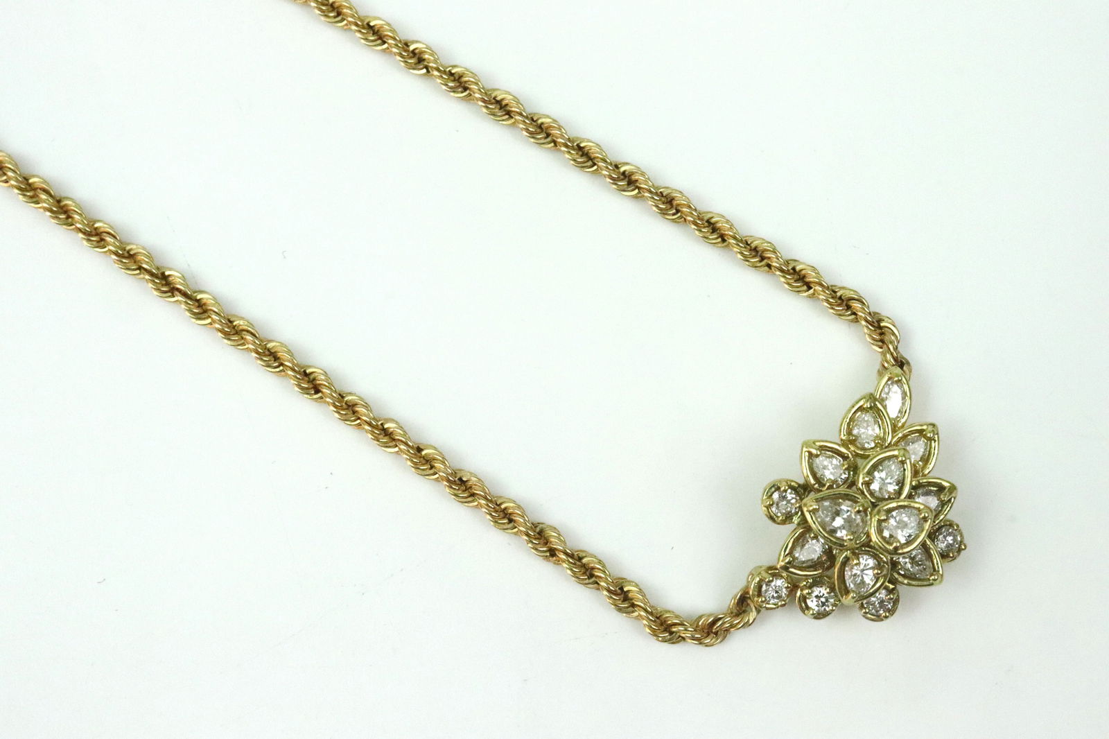 14K/18K DIAMOND PENDANT NECKLACE: comprising an 18K pendant set with 16 round and pear cut diamonds approx. 2.00ctw, 16x22mm, integrated lavalier style to 14K rope link neckchain, 18in., each aptly stamped, 15.9gms., Opening Bid $700