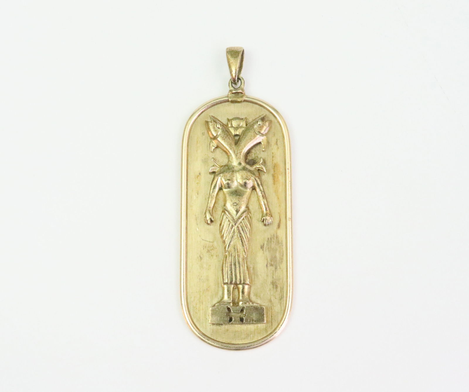 14K ZODIAC PISCES PENDANT: likely depicting the Egyptian deity Hatmehit the fish goddess, stamped 14K, bale tests 14K, some areas of light tarnish, length 2.5in. including bale., 14.7gms., Opening Bid $700