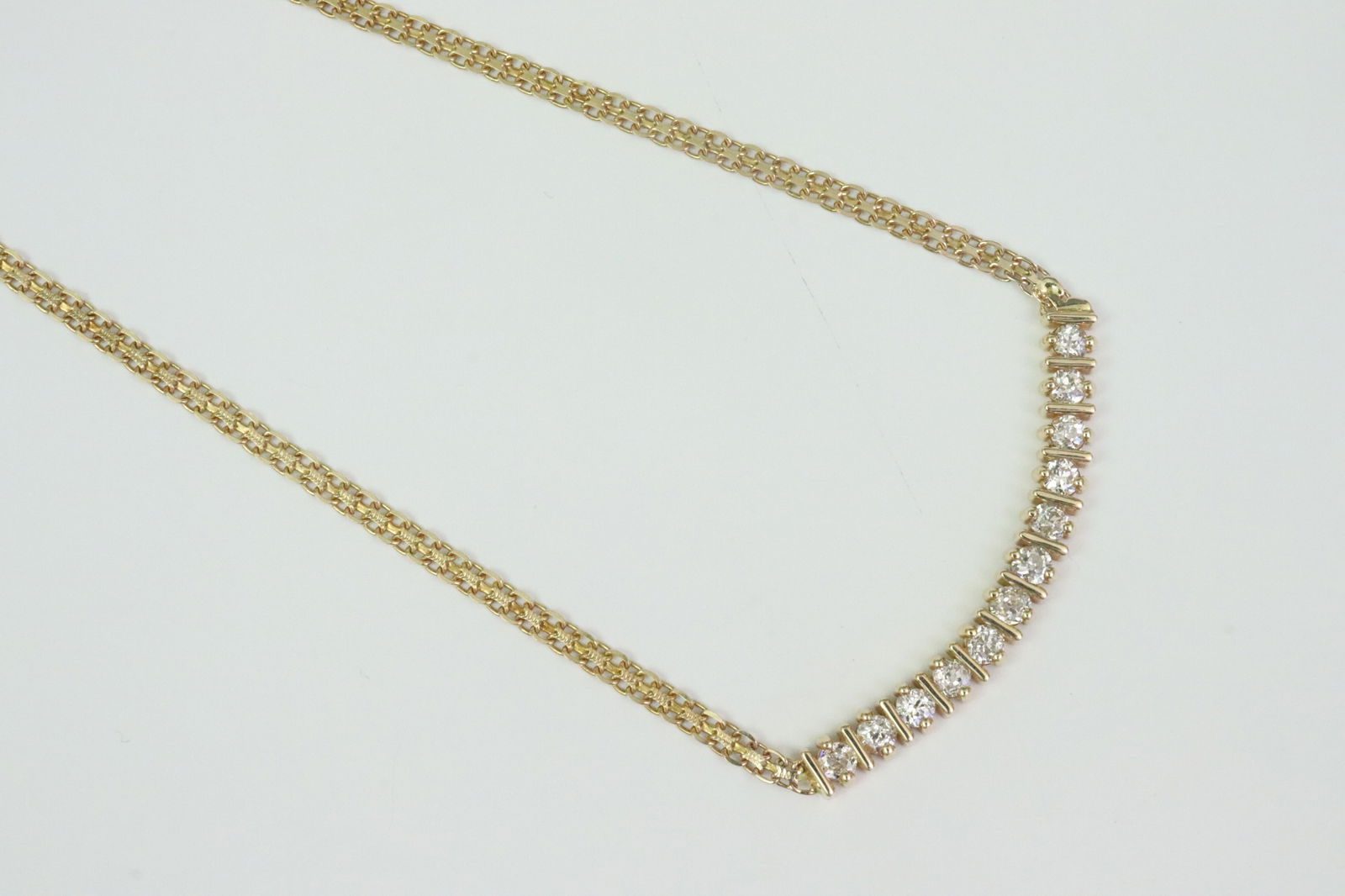 ITALIAN 14K DIAMOND BISMARCK NECKCHAIN: featuring 12 round bar-set diamonds approx. 1.10ctw, appear nice clean stones, stamped '14K Italy', 15.5in., 7.3gms., Opening Bid $500