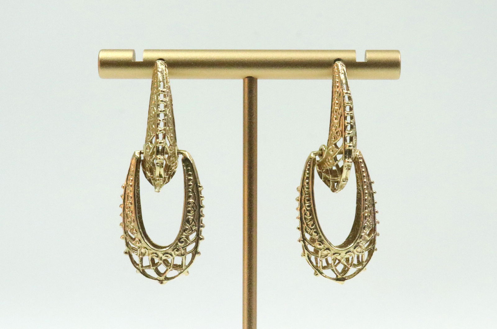 PAIR 14K EGYPTIAN REVIVAL STYLE DANGLE EARRINGS: in yellow filigree gold, test 14K, earring backs stamped 14K, hoop width .6in., overall length 1.7in., 9.1gms., Opening Bid $400