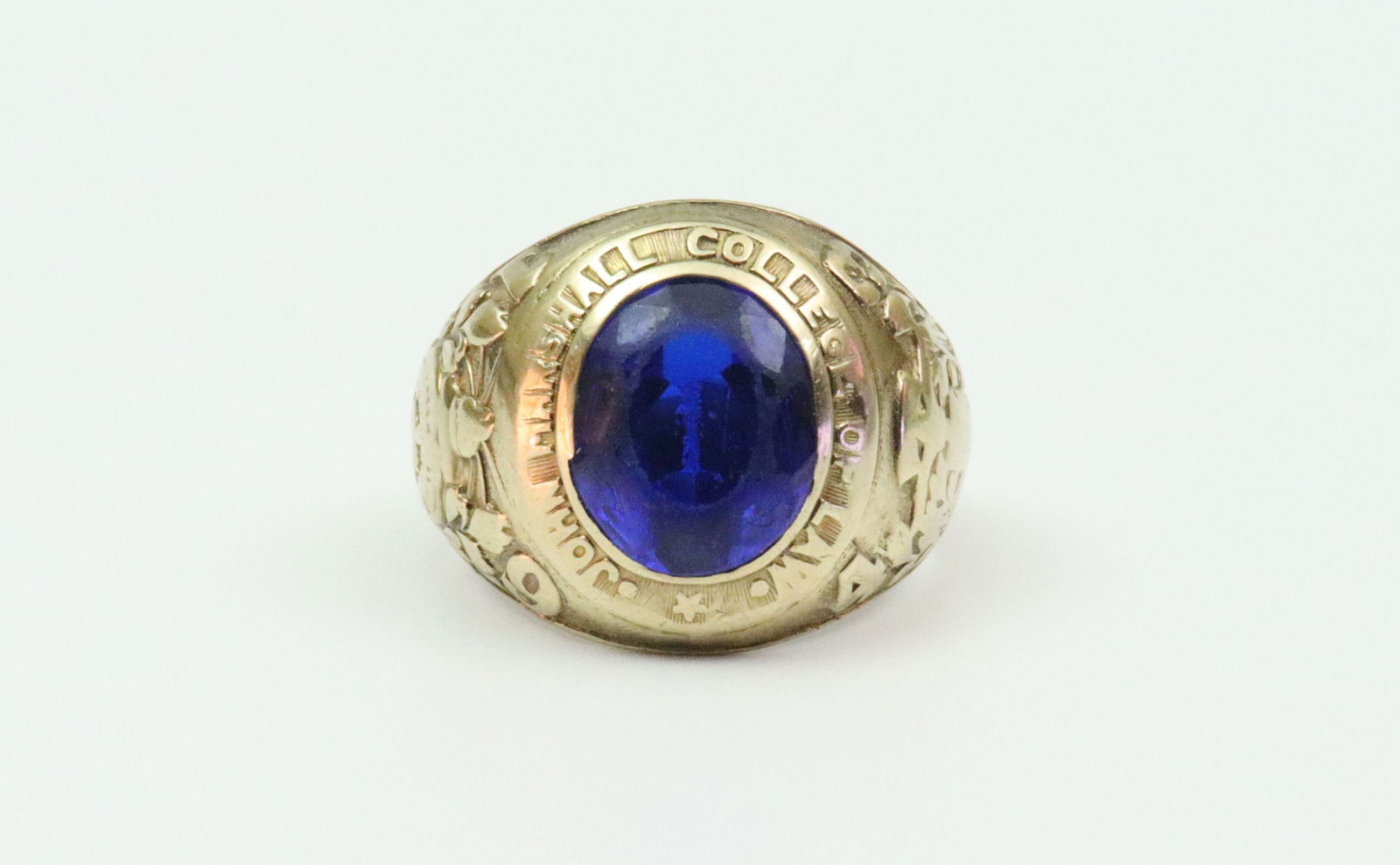 1943 10K COLLEGE RING: 1943 John Marshall College of Law, set with a blue spinel stone (stone well scuffed, shank with slight bend), height 18mm, stamped 10K, and with engraved initials, size 9.25, 12.1gms., Opening Bid $40
