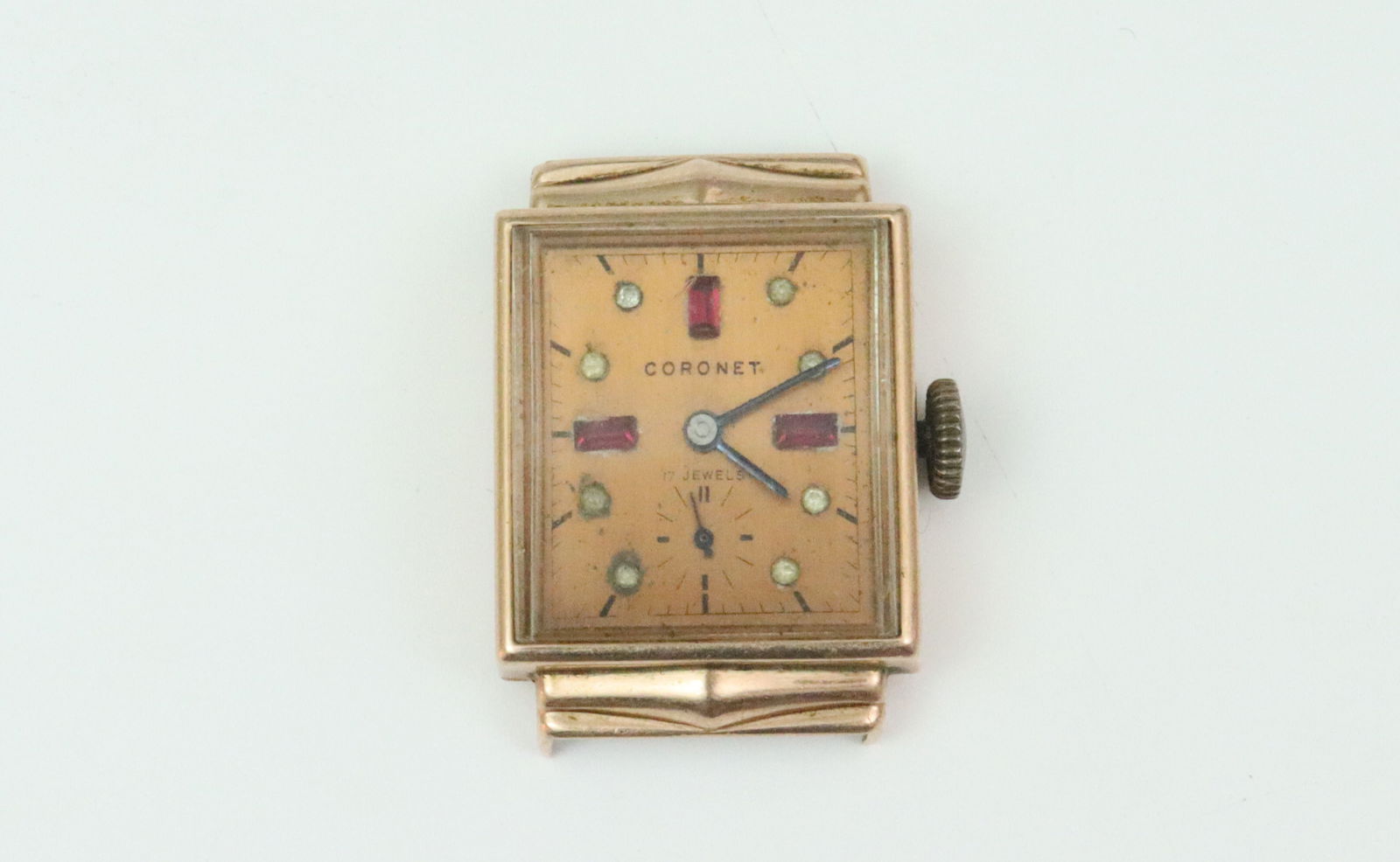 14K CORONET ROSE GOLD CASE WATCH: 21x30mm, rose gold-toned dial stamped 'Coronet 17 Jewels', clear and red glass hour markers, seconds subdial, case stamped 14K, manual movement stamped 'Coronet Watch Company Swiss 17 Jewels', no