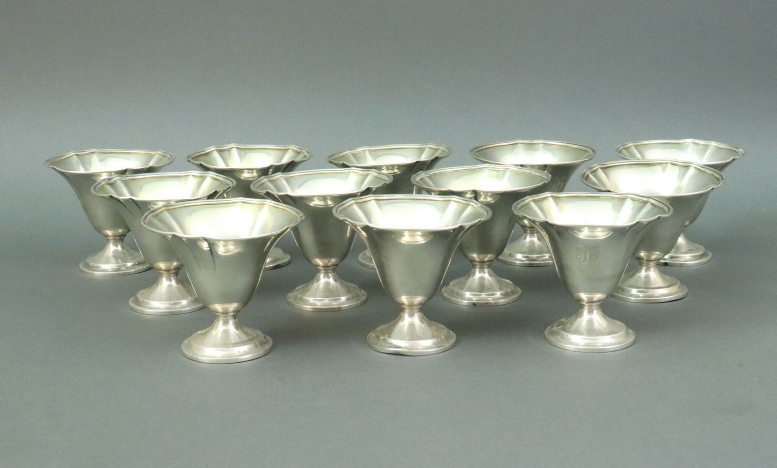 (12) DOMINICK & HAFF STERLING SUNDAE CUPS: fluted rims, stamped #483, 3x3.5in., several very minor dings, monogrammed, 22.1ozt., Opening Bid $800