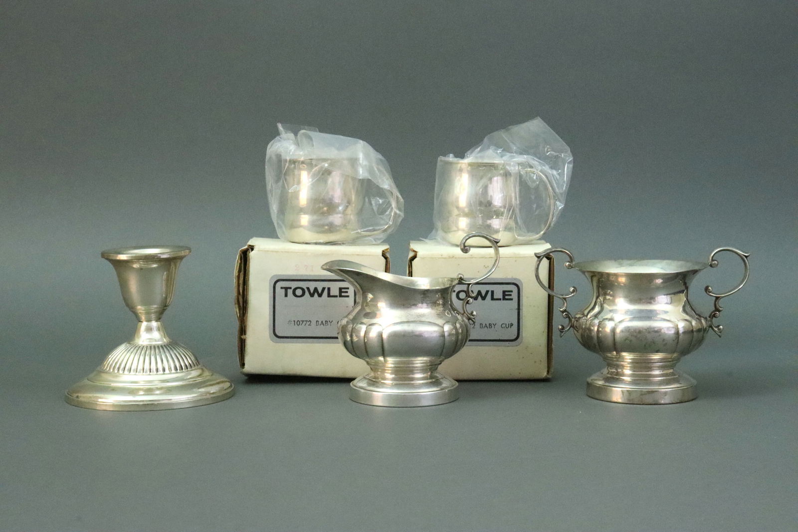 (5) PIECE STERLING GROUP: includes 2 vintage (new in box) Towle #10772 baby cups, a Poole #567 cream & sugar pair in Georgian pattern, and a Fisher weighted candle holder (base rubs), no monograms, 13ozt. weighable silver,