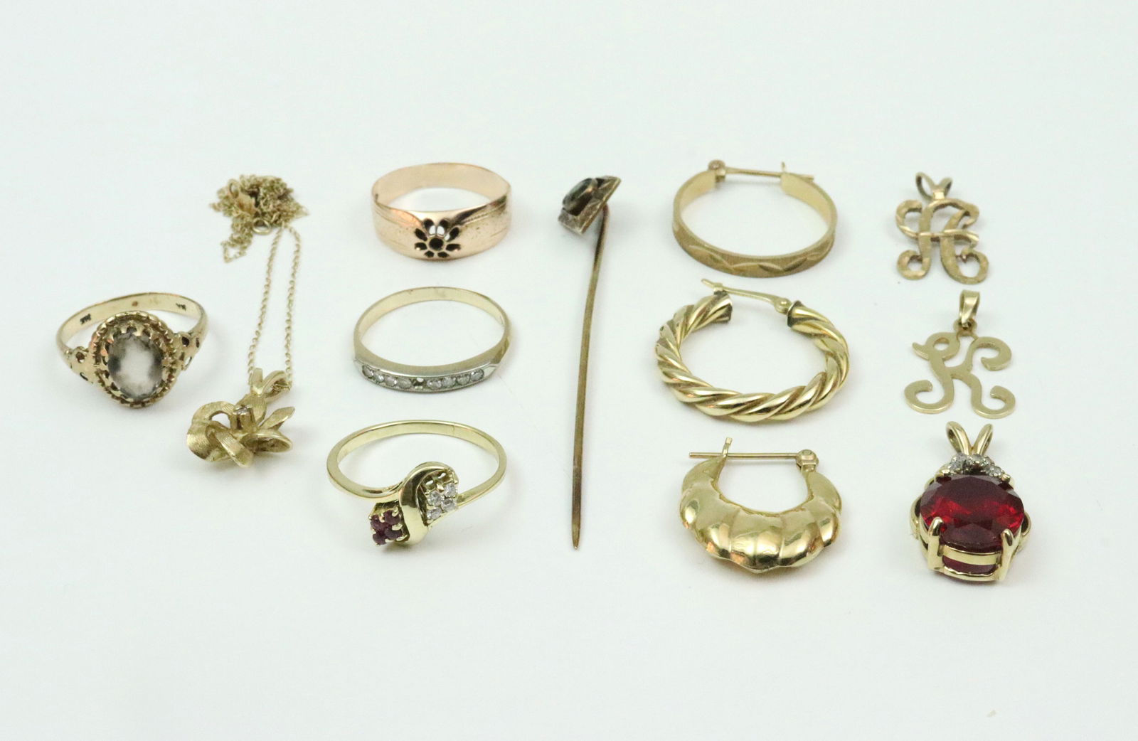 (13) PIECE GOLD JEWELRY GROUP: rings include an 8-stone channel set diamond melee ring (one diamond missing), size 5.5, a diamond and ruby 8-stone bypass ring, size 6, a rose gold cut-out floral band (possibly missing stones),
