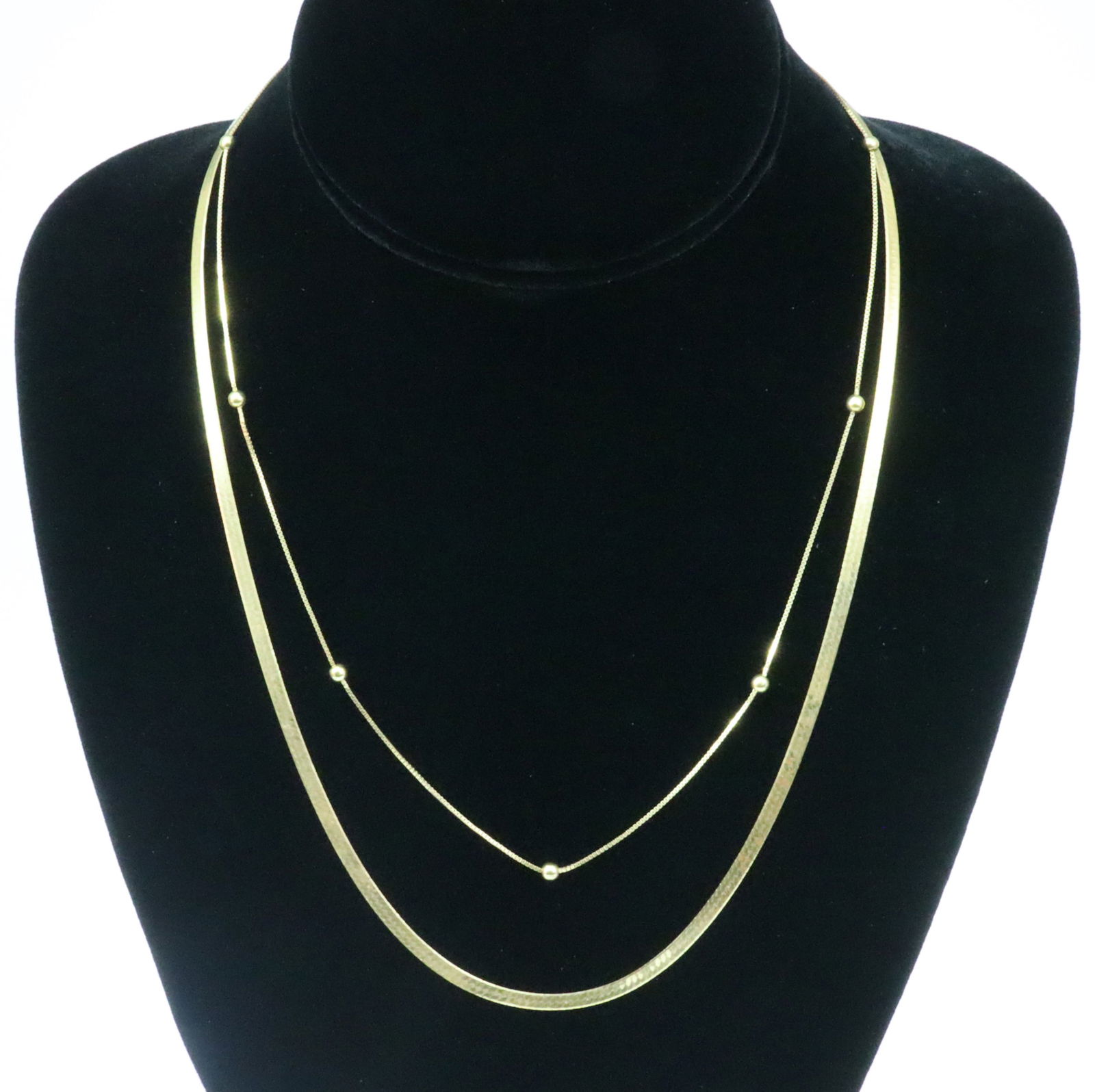 (2) 18K ITALIAN NECKCHAINS: including a 20" herringbone, stamped 'Italy 750', and an 18" box link with ball spacers, stamped 750, and with Italian hallmark 770 AR (Arezzo), gross weight 9.7gms., Opening Bid $600