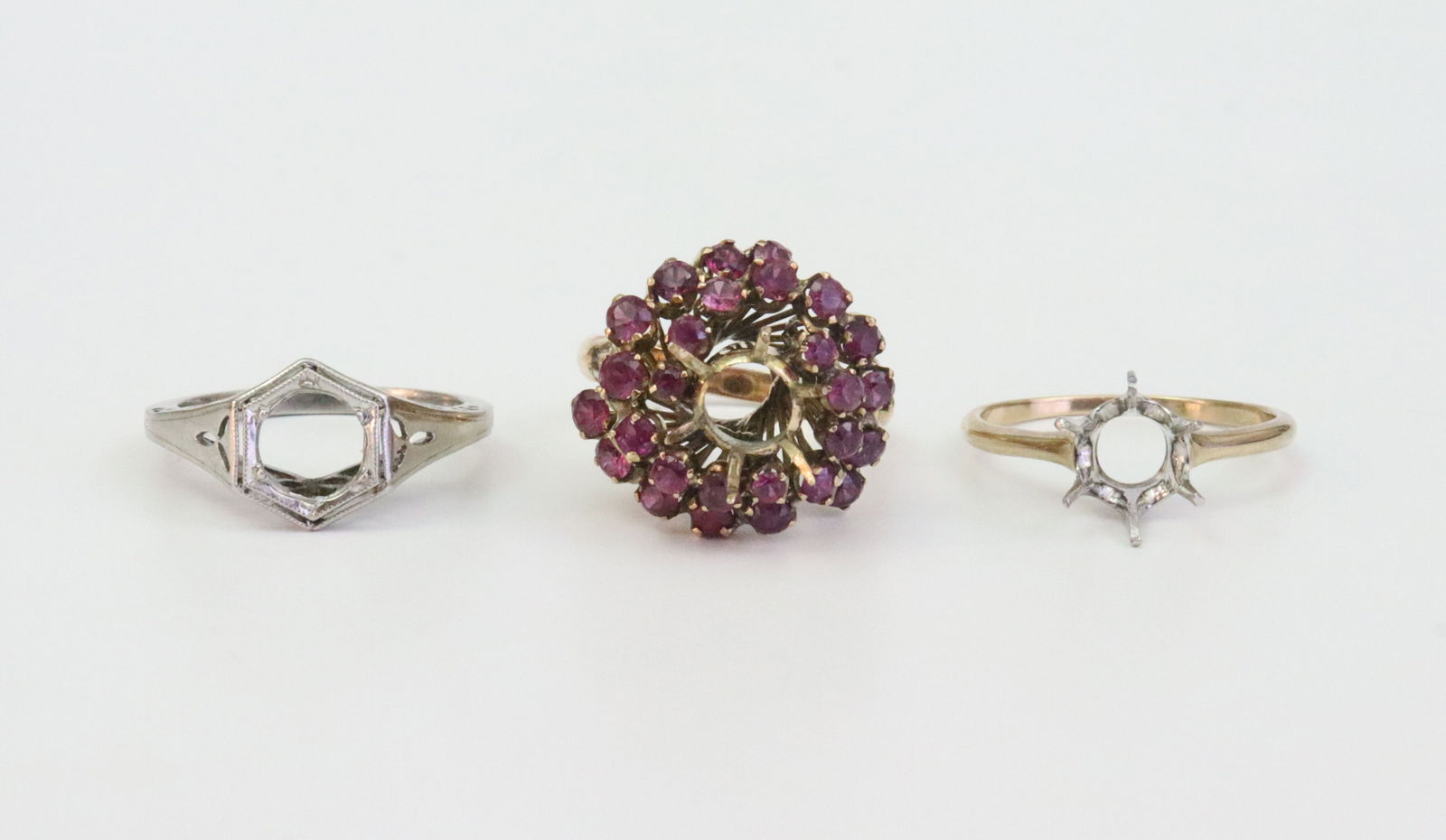 (3) 14K & PLATINUM RING SETTINGS: including an Art Deco tested platinum filigree solitaire setting (lacking stone), size 6.5, 3.8gms., a ruby cocktail ring spiral set with 27 graduated rubies approx. 1.35ctw (lacking center stone), st