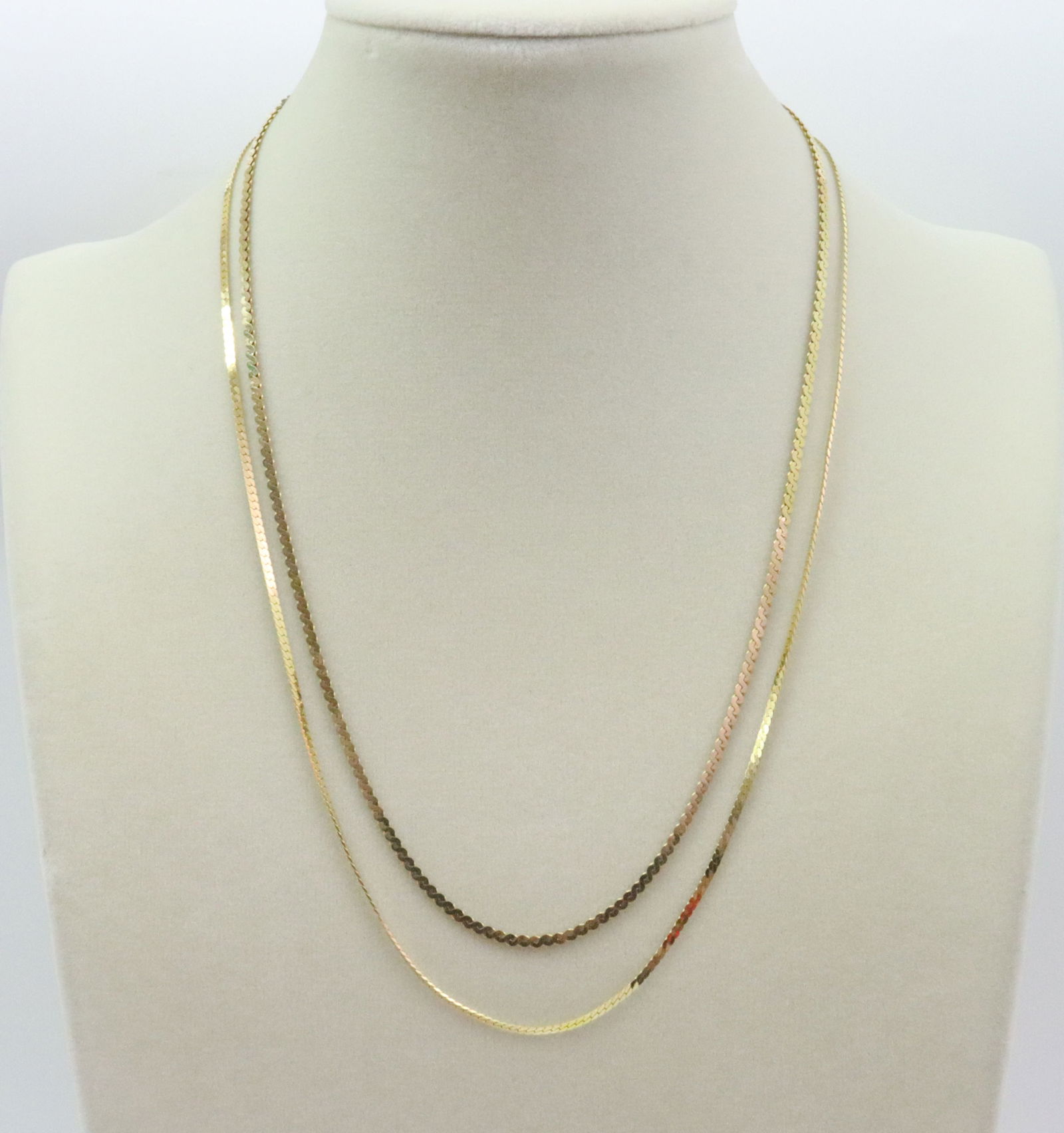 (2) 14K NECKCHAINS - HERRINGBONE & SERPENTINE: including a 19.5" herringbone, and an 18" serpentine, each stamped '14K Italy', gross weight 10.9gms., Opening Bid $500