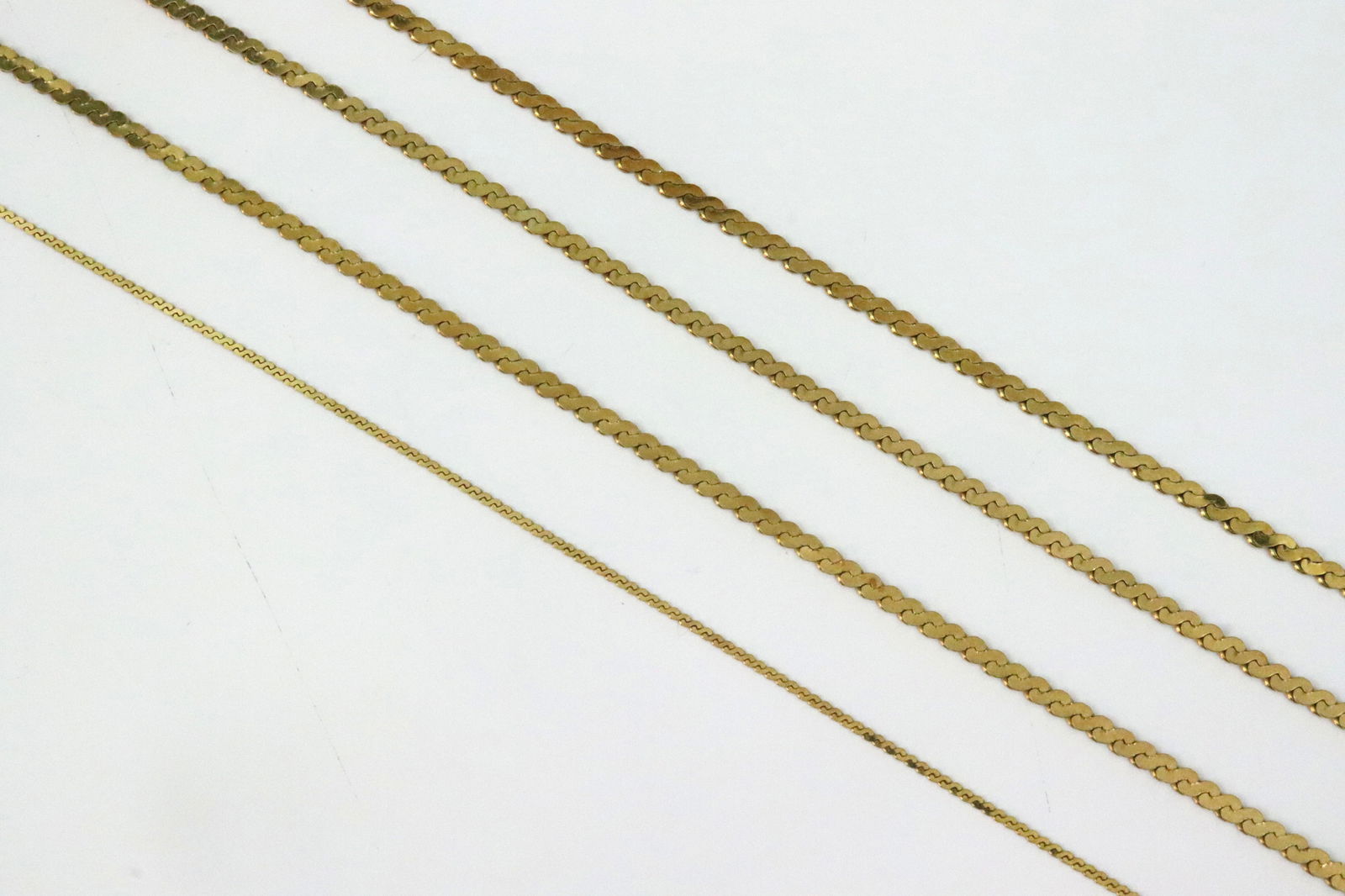 (3) 14K SERPENTINE LINK BRACELETS AND AN ANKLET: including 3 (6.75-7.25") bracelets and a (9") anklet / bracelet, all stamped 'Italy 14K', gross weight 9gms., Opening Bid $400