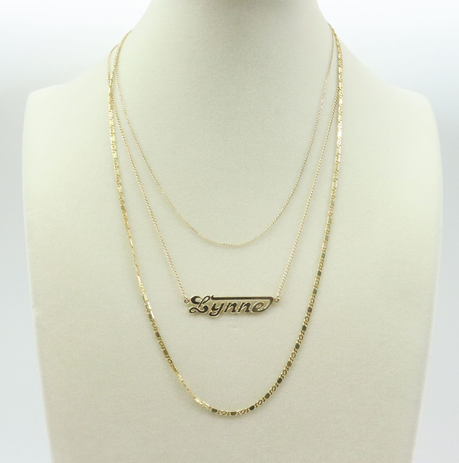 (3) 14K NECKCHAINS: including a 20in. figaro chain marked Italy, a 17in. "Lynne" signet cable chain, and a 15in. cable trace chain (gold hang tag broken, solder remnant at jump ring), all stamped 14K, gross weight