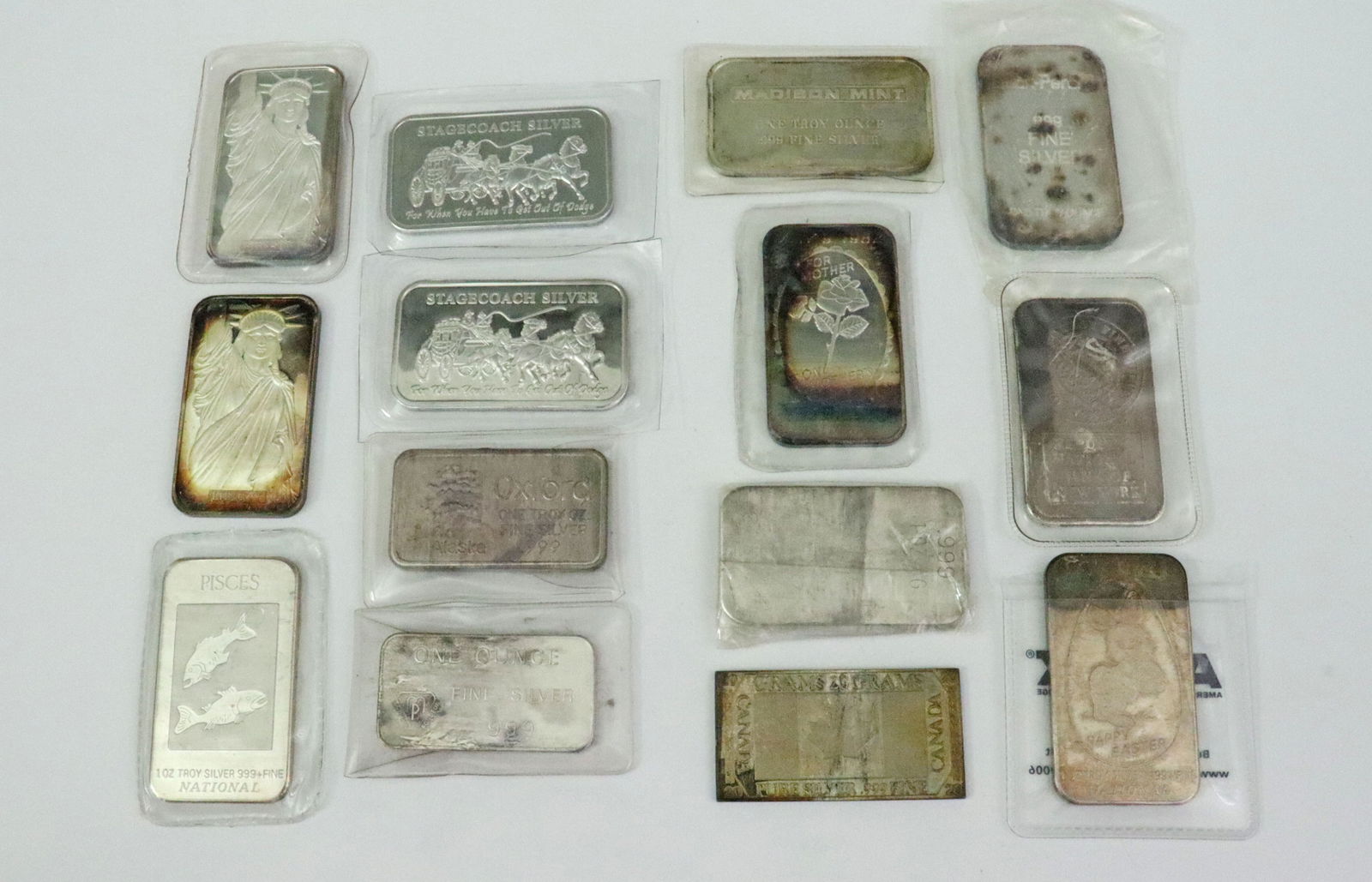 (13) ASSORTED 1 TROY OZ .999 SILVER BARS: by various makers and subjects including MTB (Statue of Liberty), National (Mother's Day, Happy Easter and Pisces), JM, Oxford, MP, Madison Mint, Deak-Perera, Stagecoach Silver, etc., together with a