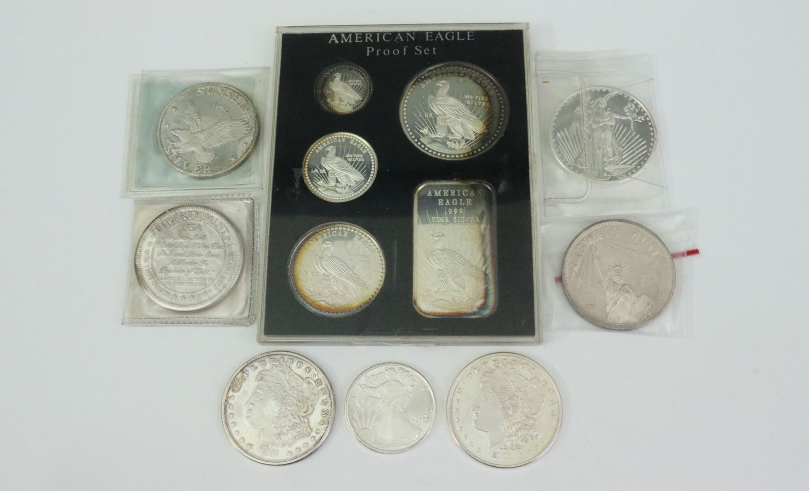 (12) ASSORTED .999 SILVER ROUNDS & BAR: includes a 5-piece packaged 1981 Worldwide Mint 'American Eagle' set comprised of a 1oz bar and 4 rounds (1oz., 1/2oz., 1/4oz. and 1/10oz.), 1oz rounds include 2 Sunshine Mint Morgan dollar