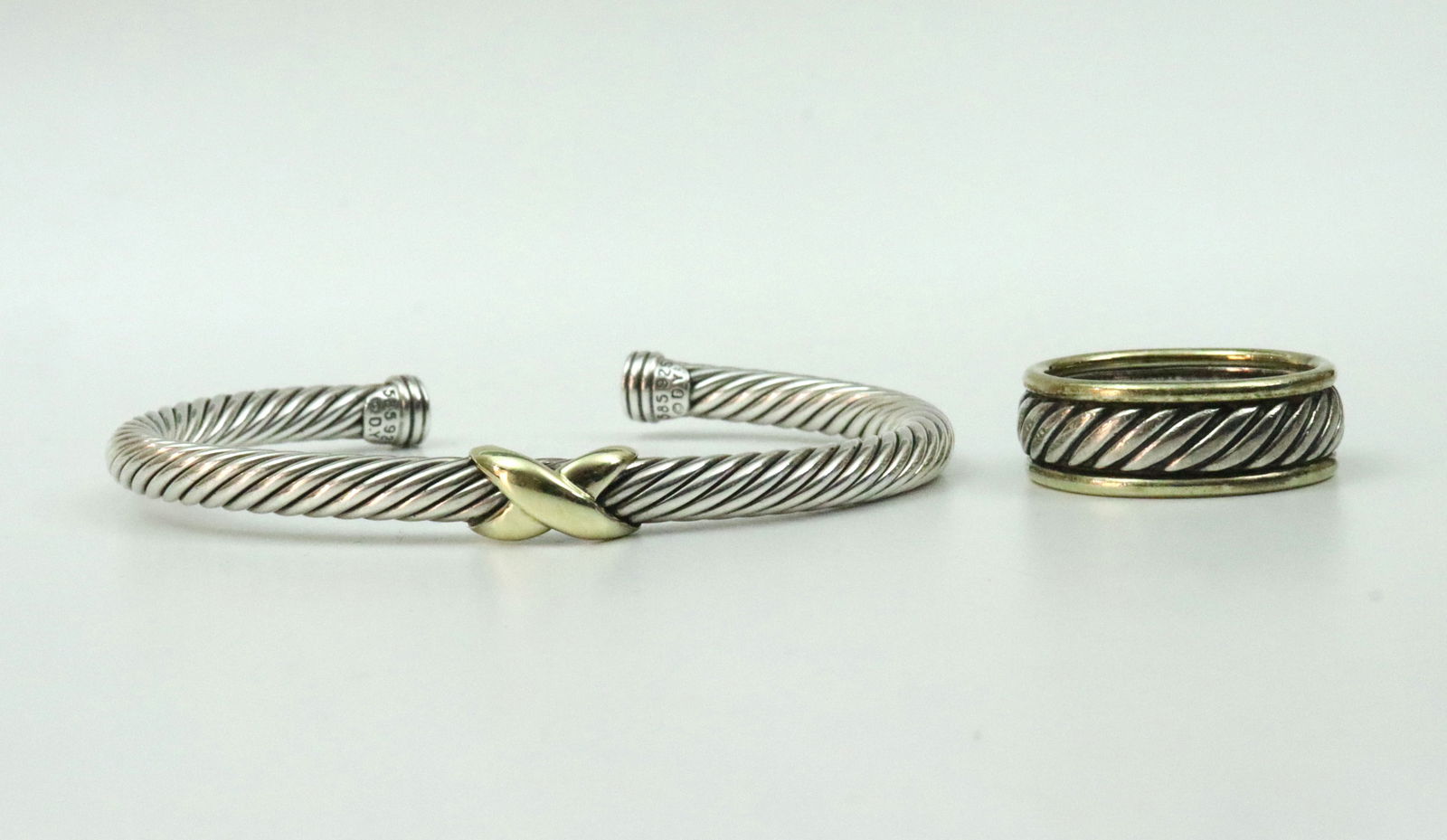 DAVID YURMAN 925 / 585 CUFF & GENT'S RING: including a flex cable X cuff, width 5mm, stamped '585 925 DY', 28.8gms., and a gent's inset cable band ring, stamped 'D. Yurman 925 585 M', width 8.5mm, size 10.75, 10.9gms., gross weight for the