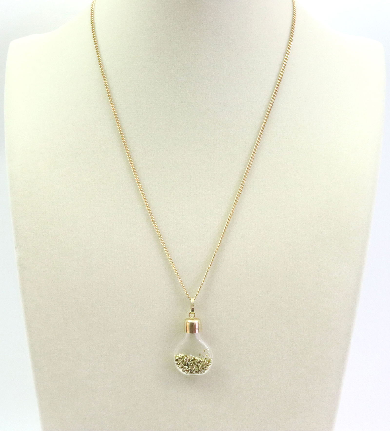 14K CURB LINK CHAIN WITH 14K GOLD DUST PENDANT: comprising a curb link neckchain stamped '14K Italy', 18in., 5.3gms., and a glass gold dust flask pendant with 14K cap and bale, 1.4in. including bale, 2.9gms., gross weight 8.3gms., Opening Bid $300