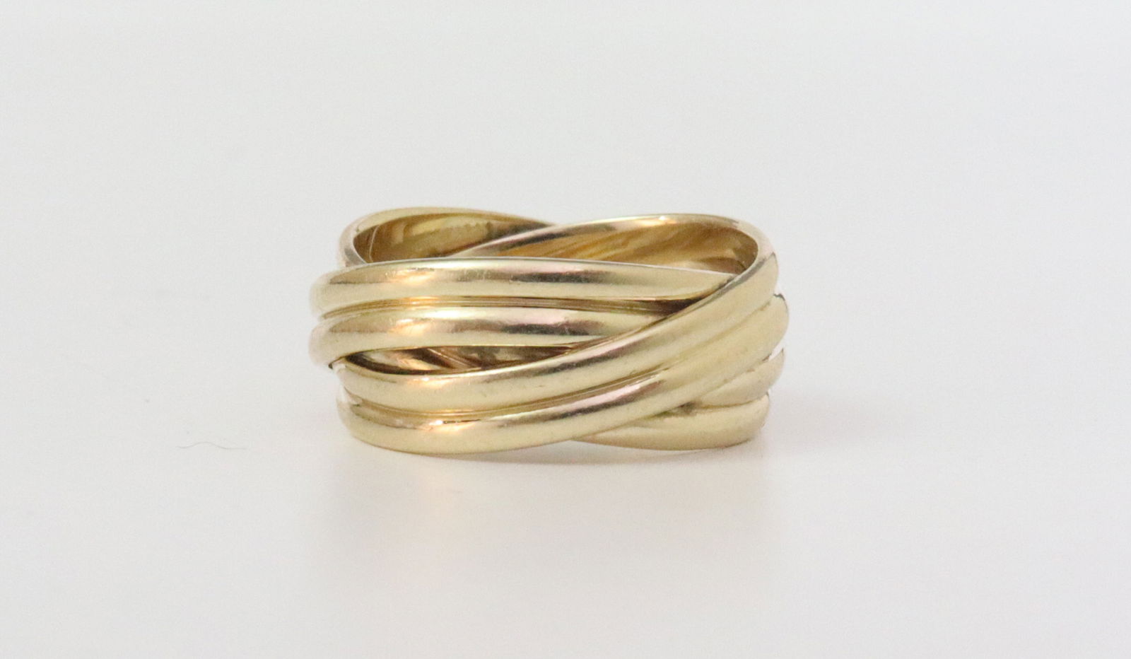 14K CROSSOVER GOLD BAND: in yellow gold, stamped 'Artcarved 14KT', size 5, width 7.5mm, 5.3gms., Opening Bid $250