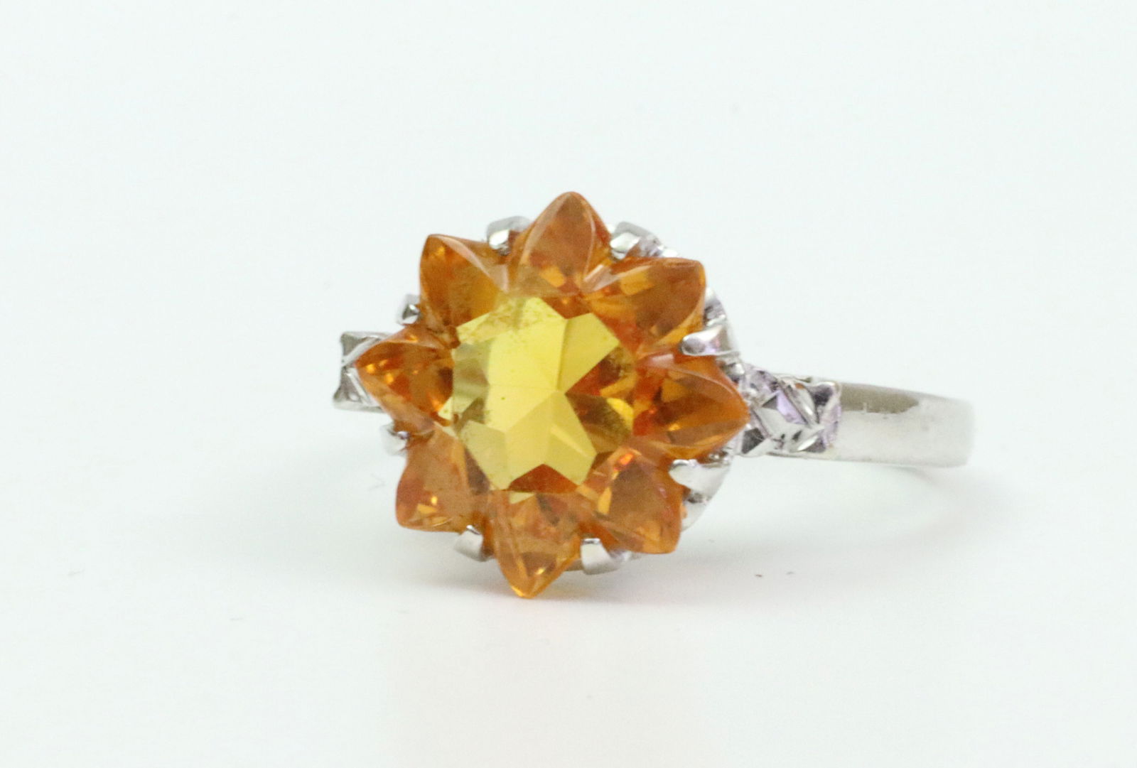 14K RETRO FLOWER CUT SPESSARTITE GARNET RING: set with a flower cut mandarin orange spessartite garnet approx. 12.7mm point to point, in white gold, stamped 14K, size 5.75, 4.7gms.Note: While the garnet exhibits a uniform mandarin orange