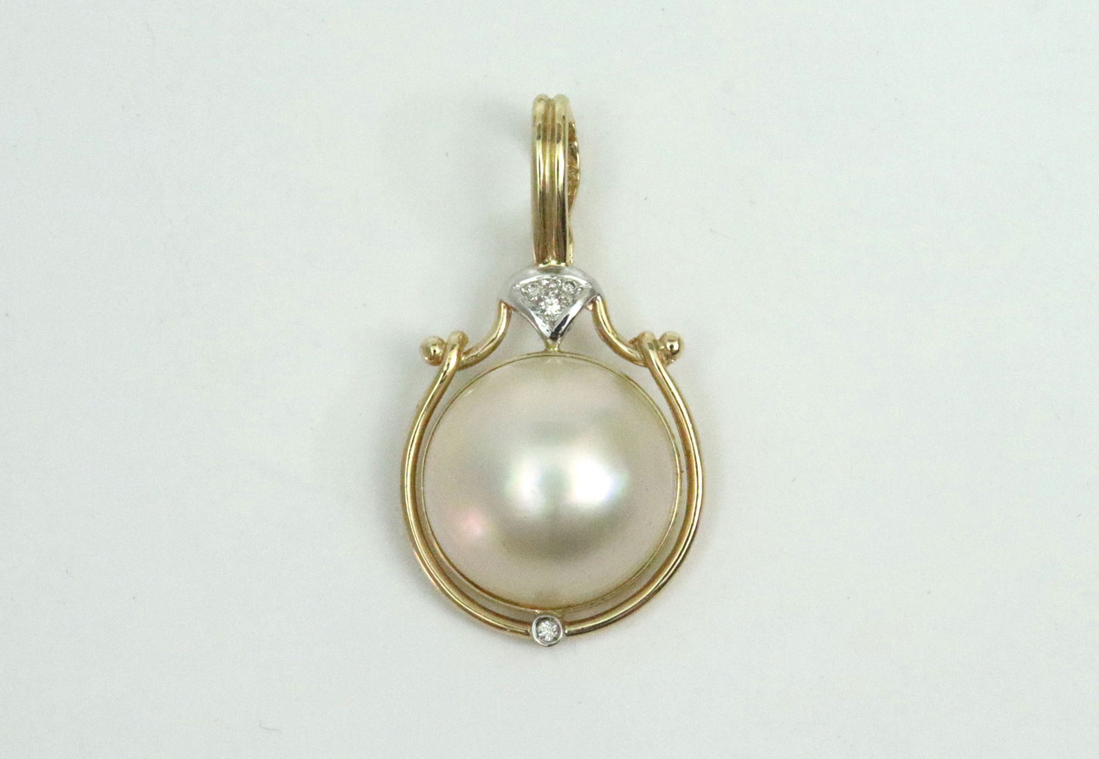 14K MABE PEARL ENHANCER: set with a (15mm) mabe pearl accented with 4 melee diamonds, overall 1.3in., in yellow gold, stamped 14K, 4.1gms.