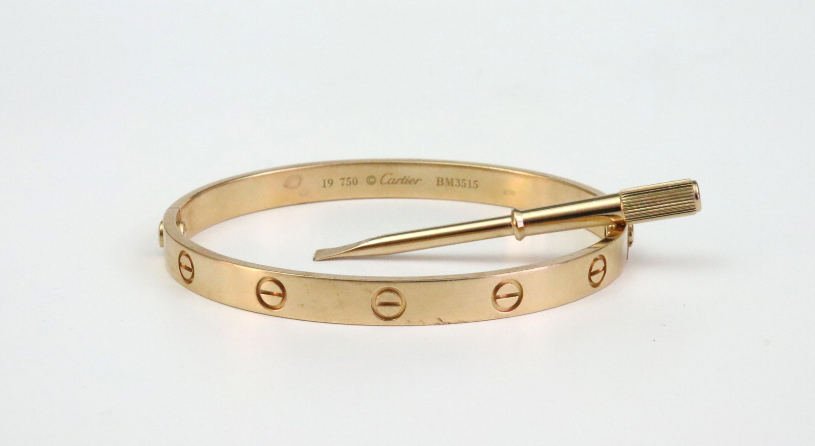 CARTIER 18K ROSE GOLD LOVE BRACELET: with signature screw top design, stamped '19 750 Cartier BM3515', and with Italian hallmark 1 TO (Torino), interior diameter approx. 7in., mild surface scratches and a few edge dings, with Cartier