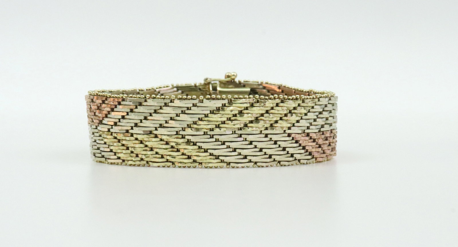 ITALIAN TRICOLOR 14K MESH LINK BRACELET: in geometric design with bead trim, width 16mm, length 7.1in., in yellow, white and rose gold, stamped 'K14 Italy', double safety, 50.5gms., Opening Bid $2500