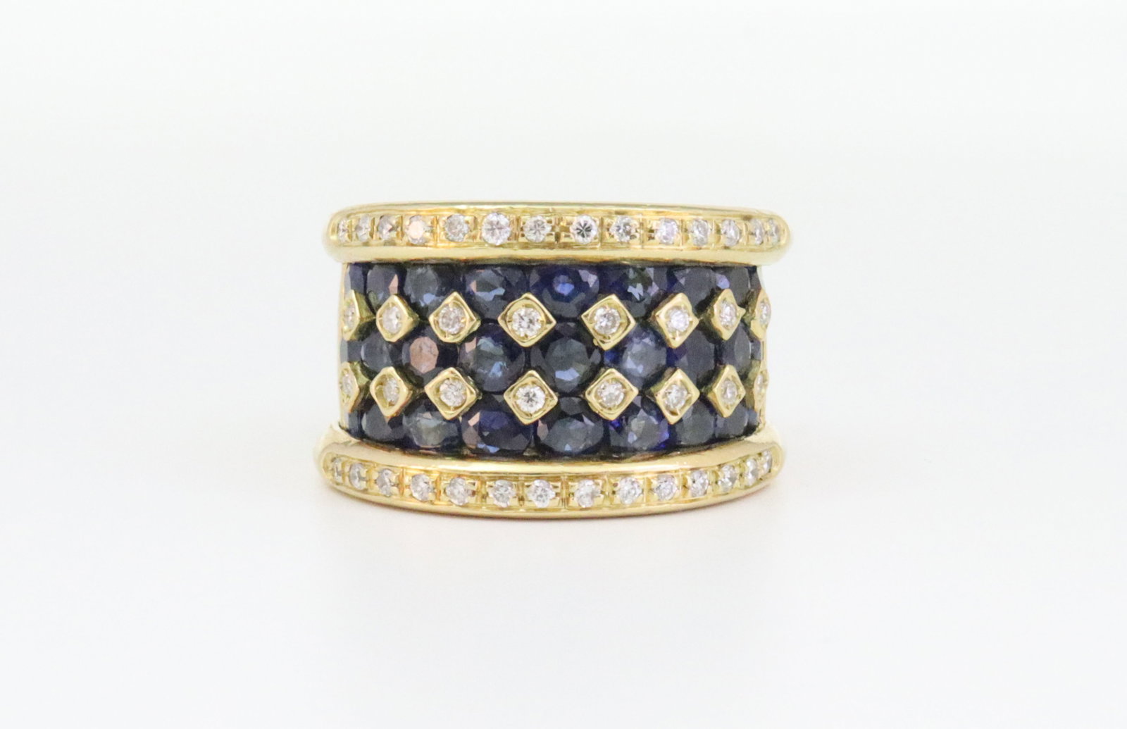 18K SAPPHIRE & DIAMOND WIDE BAND RING: designed in a geometric pattern of 27 round sapphires approx. 2.70ctw, and 44 round natural melee diamonds approx. 0.30ctw, in yellow gold, stamped 750, width 14mm, size 4, a bit off-round, 15.8gms., 