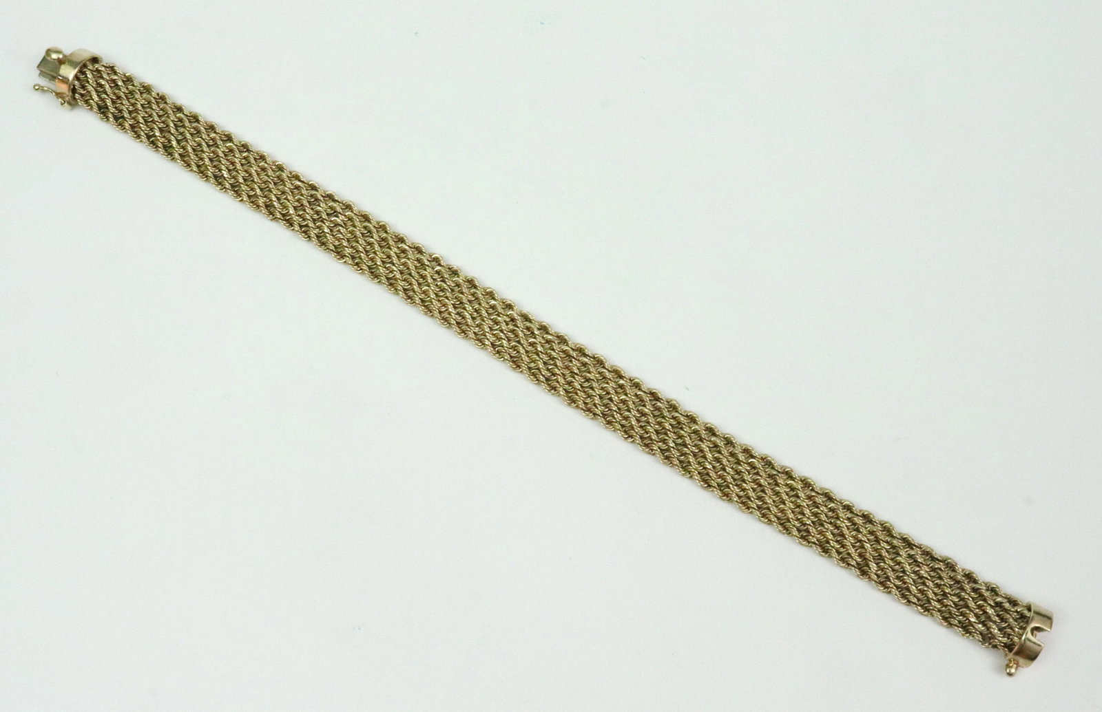 14K ROPE MESH BRACELET: comprising multi rope-link rows, width 10mm, length 7.75in., in yellow gold, stamped '14K EG Peru', safety catch, 9.4gms., Opening Bid $400