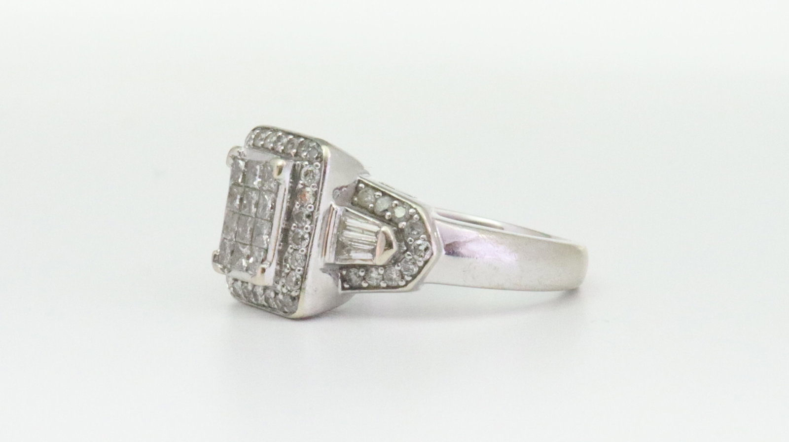 14K DIAMOND CLUSTER RING: set with 60 caliber cut, round and baguette natural diamonds approx. 1.15ctw, overall ring head 12x19mm, filigree gallery, in white gold, stamped '14K JWBR' (Renaissance Jewelry), size 7, 7.3gms.,