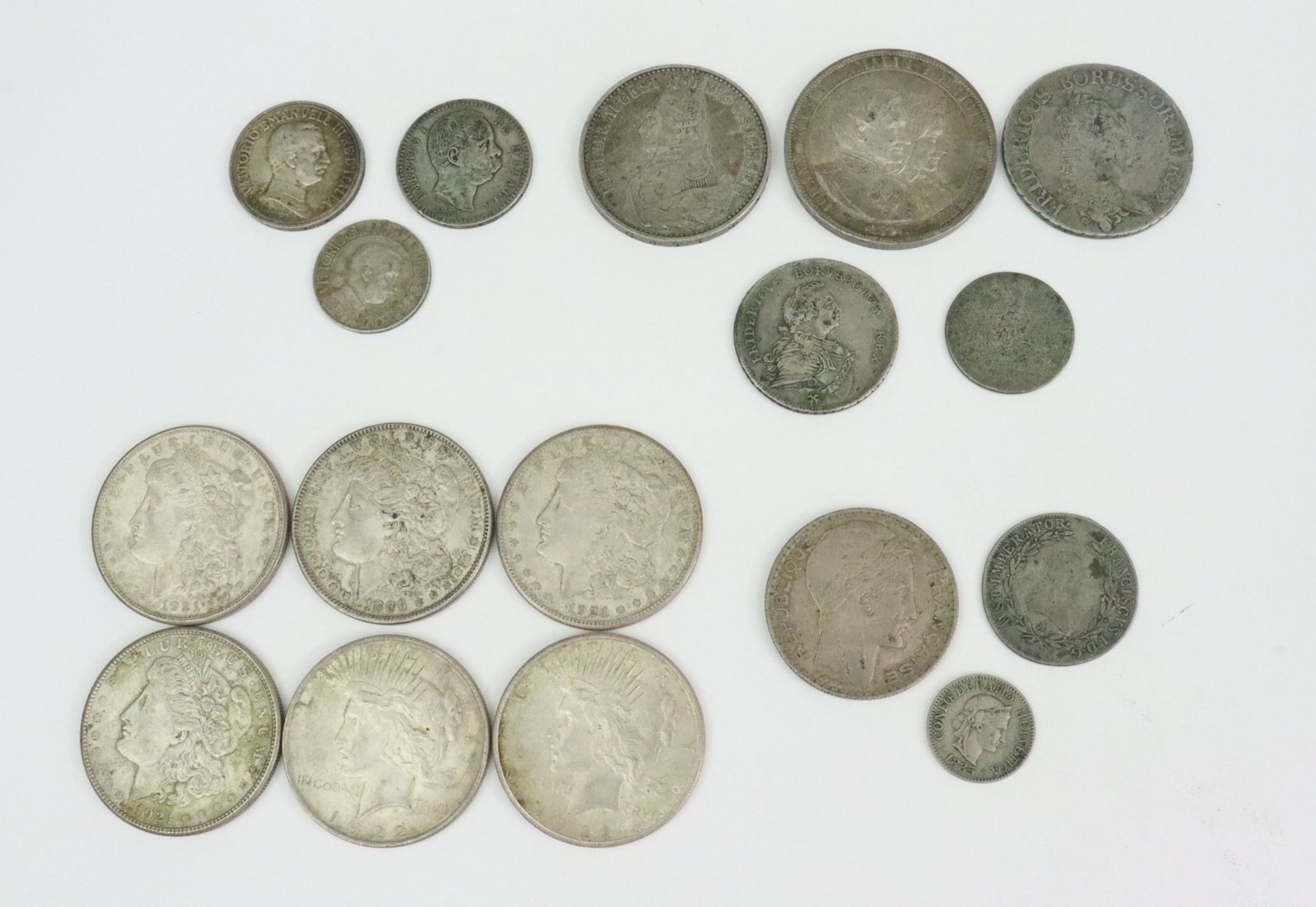 GROUP OF 16 US & INTERNATIONAL SILVER COINS: US coins include 4 Morgan dollars (1886 & 3-1921-S), and 2 Peace dollars (1922-D & 1922-S), International coins include 5 early German States examples including an 1872-B Saxony 2 Thaler (.900), an 18