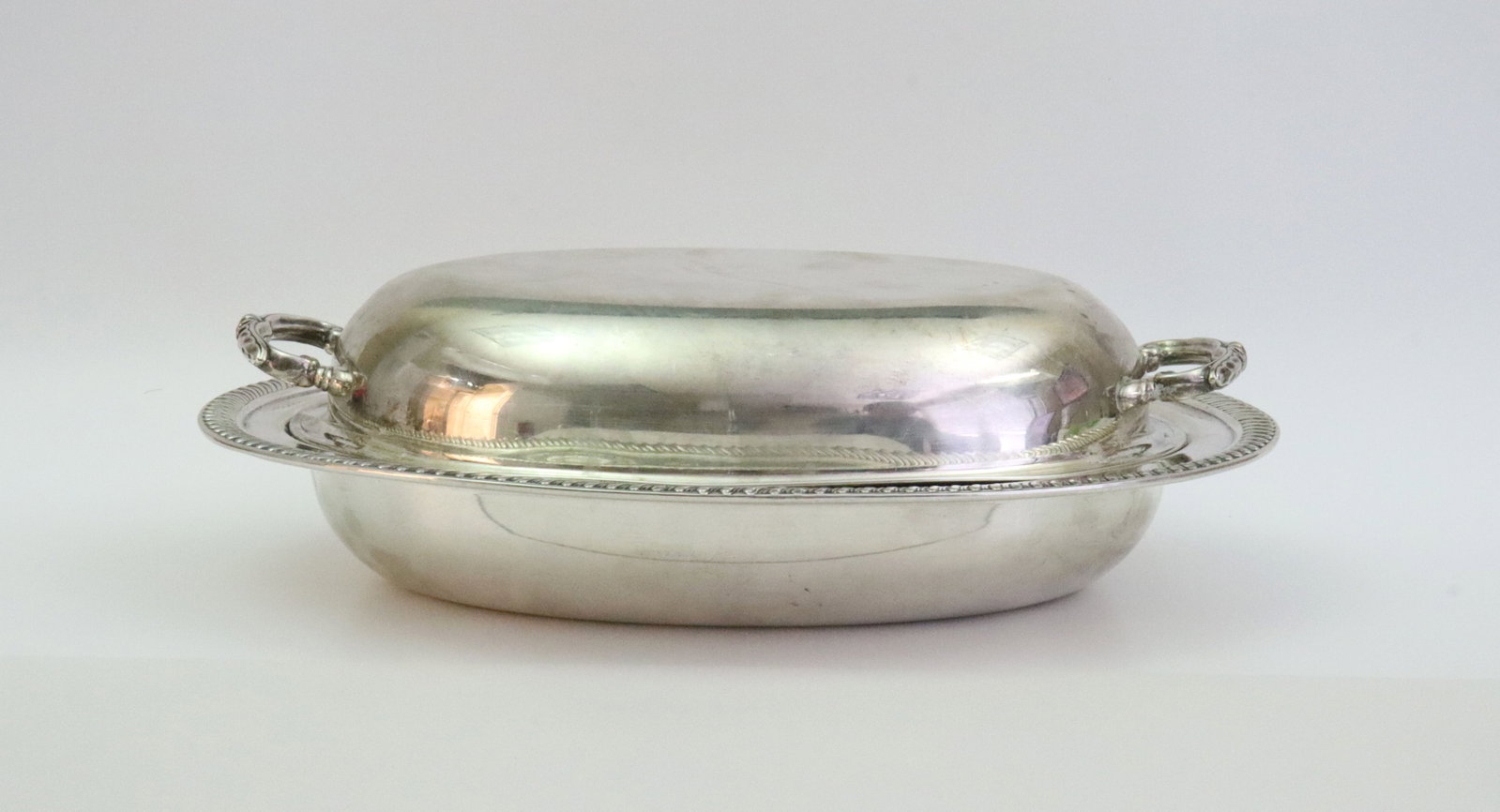 FISHER STERLING COVERED VEGETABLE SERVER: in Kent pattern, gadrooned base rim, base and matching lid stamped Sterling, the cover with very slight misshapen rim, 29.7ozt., Opening Bid $1300