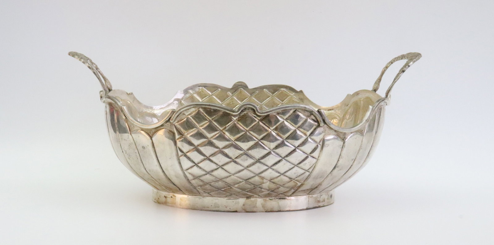 STERLING DOUBLE-HANDLED CENTER BOWL: with fluted and woven decorated body, raised edge trim, stamped 925, 13in. handle to handle, height 4.25in., 21.3ozt., Opening Bid $900